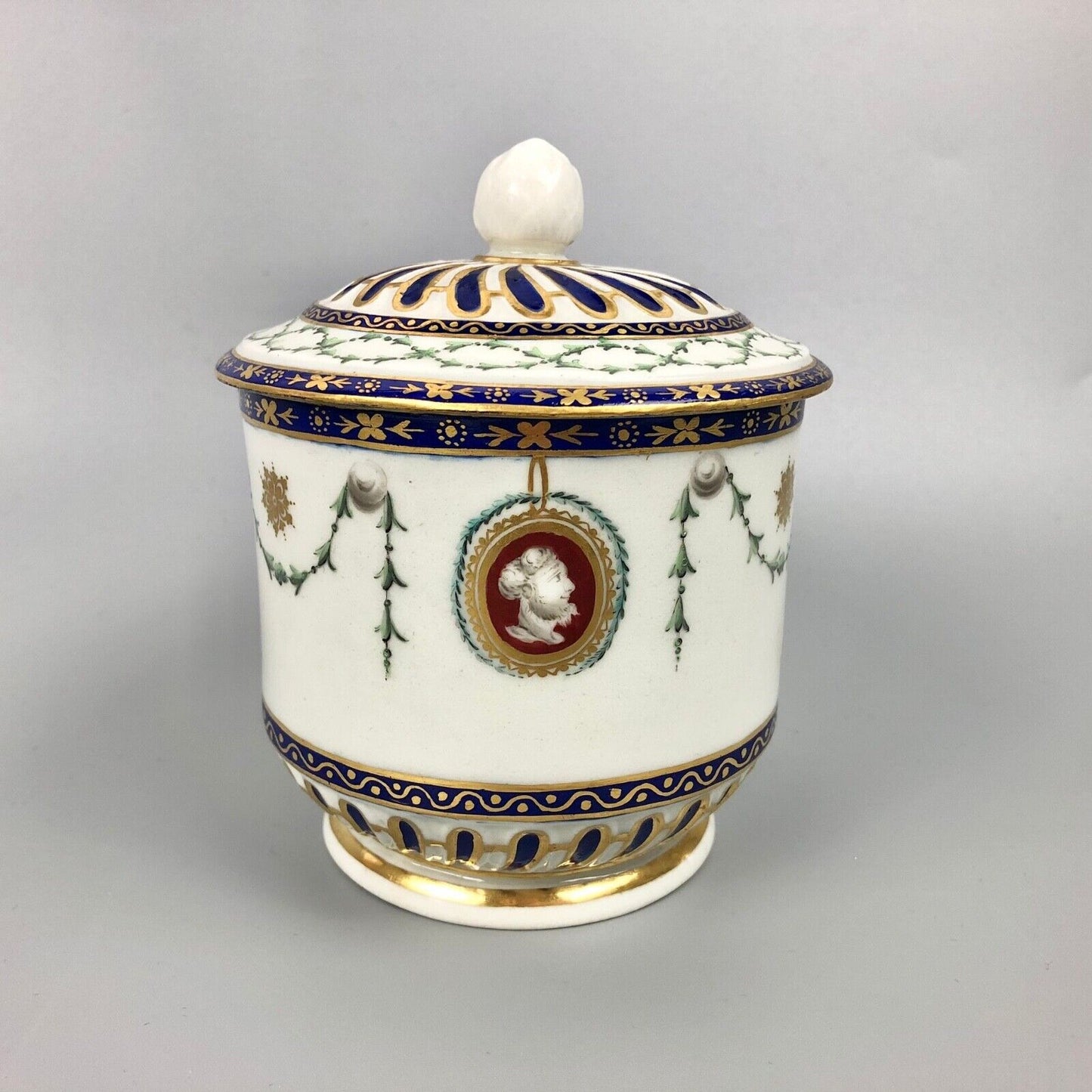 A rare Chelsea-Derby empire-shaped sucrier with classical masks. c.1770