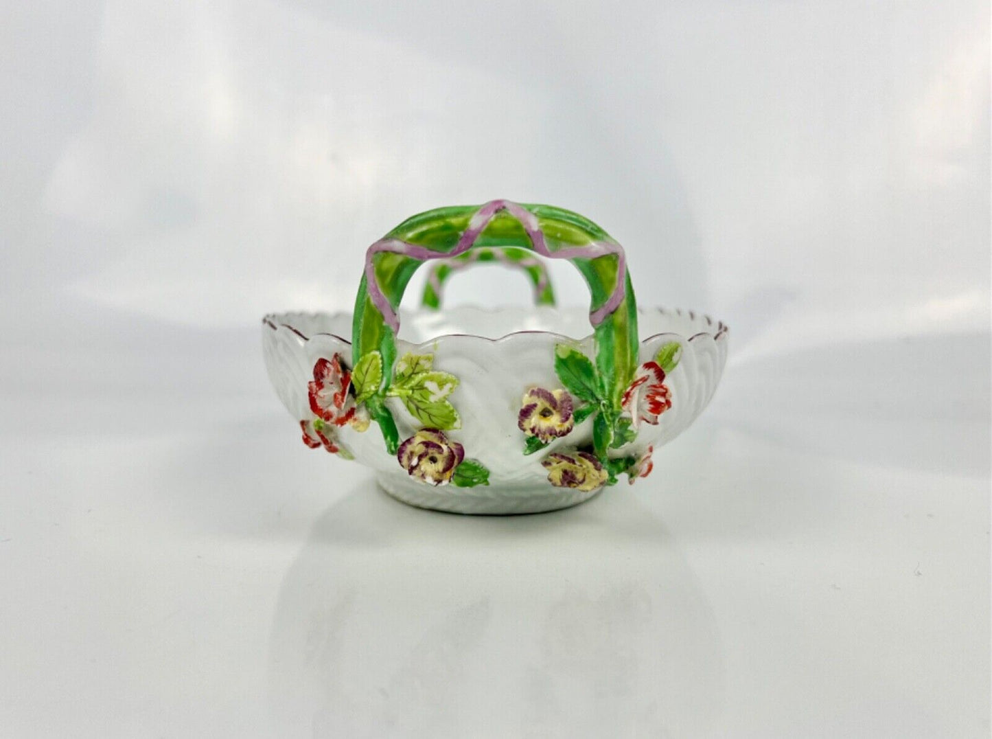 A good Chelsea basketweave moulded basket painted with bouquets. Rustic handles