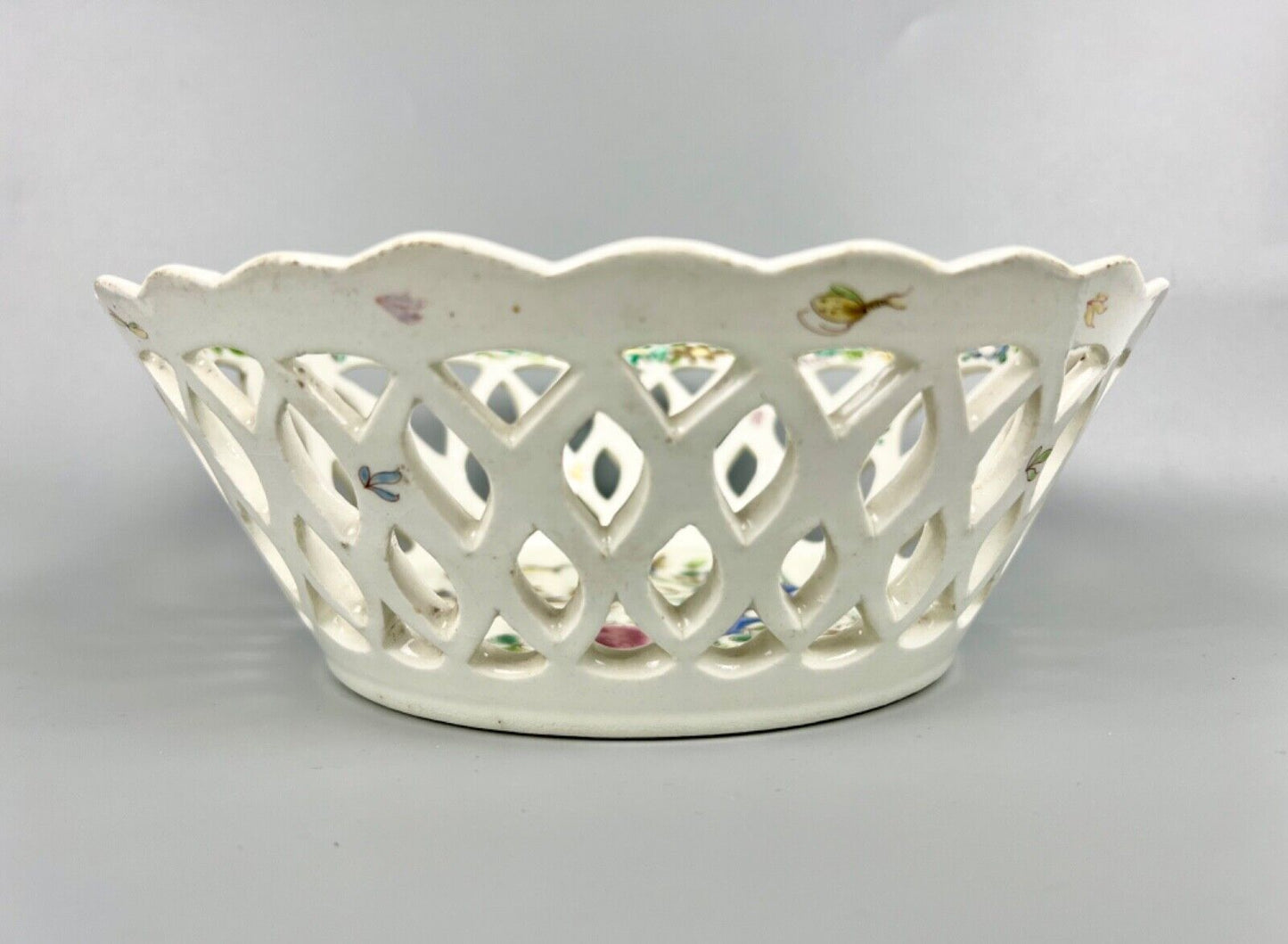 A pair of large Bow porcelain famille rose reticulated baskets c.1752
