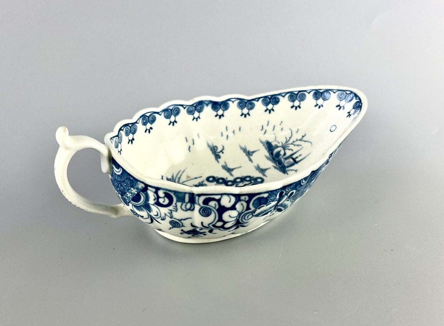 A Worcester First Period "Doughnut Tree" sauceboat. c.1777