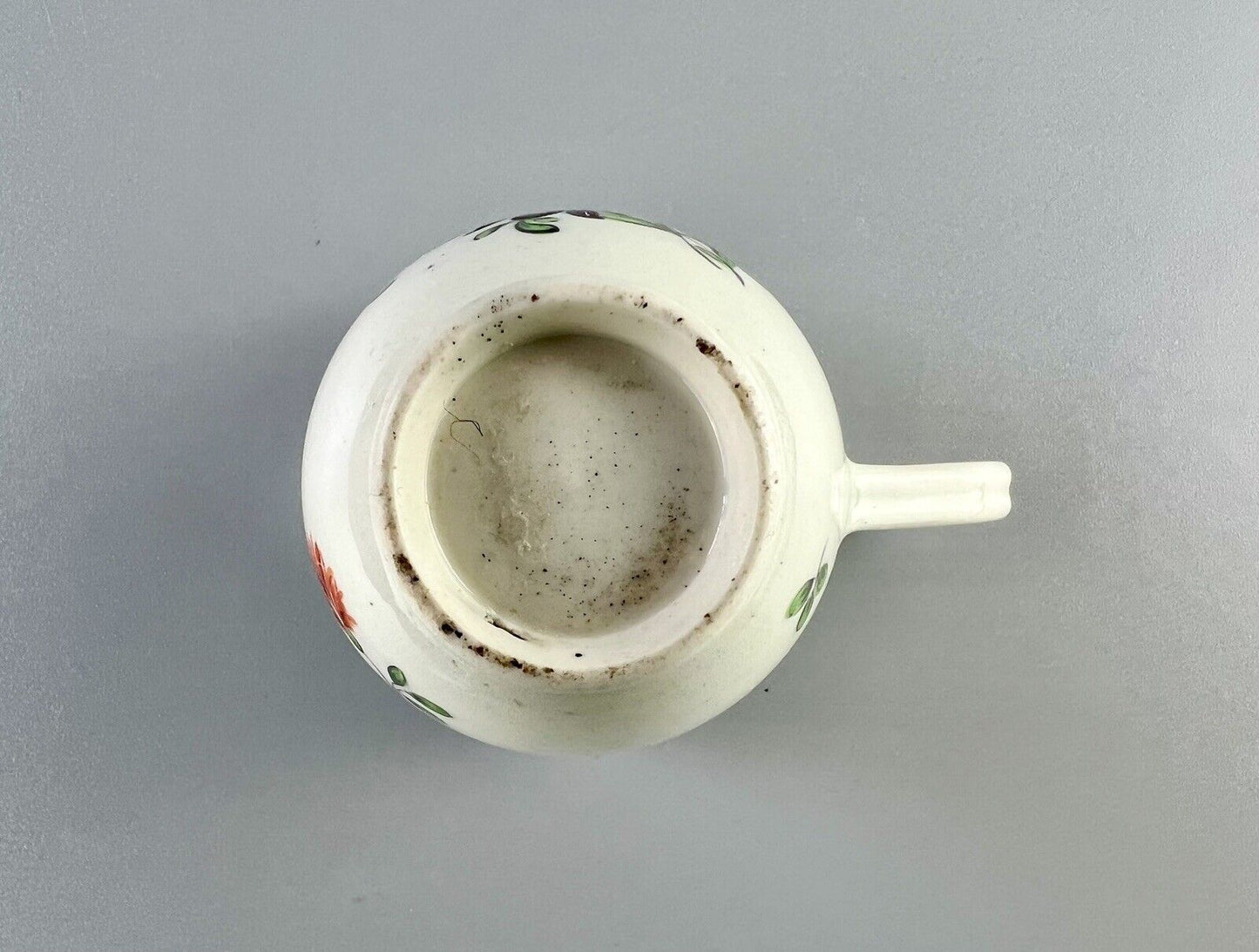 A 1st Period Worcester polychrome coffee cup c1770. Sprung handle.