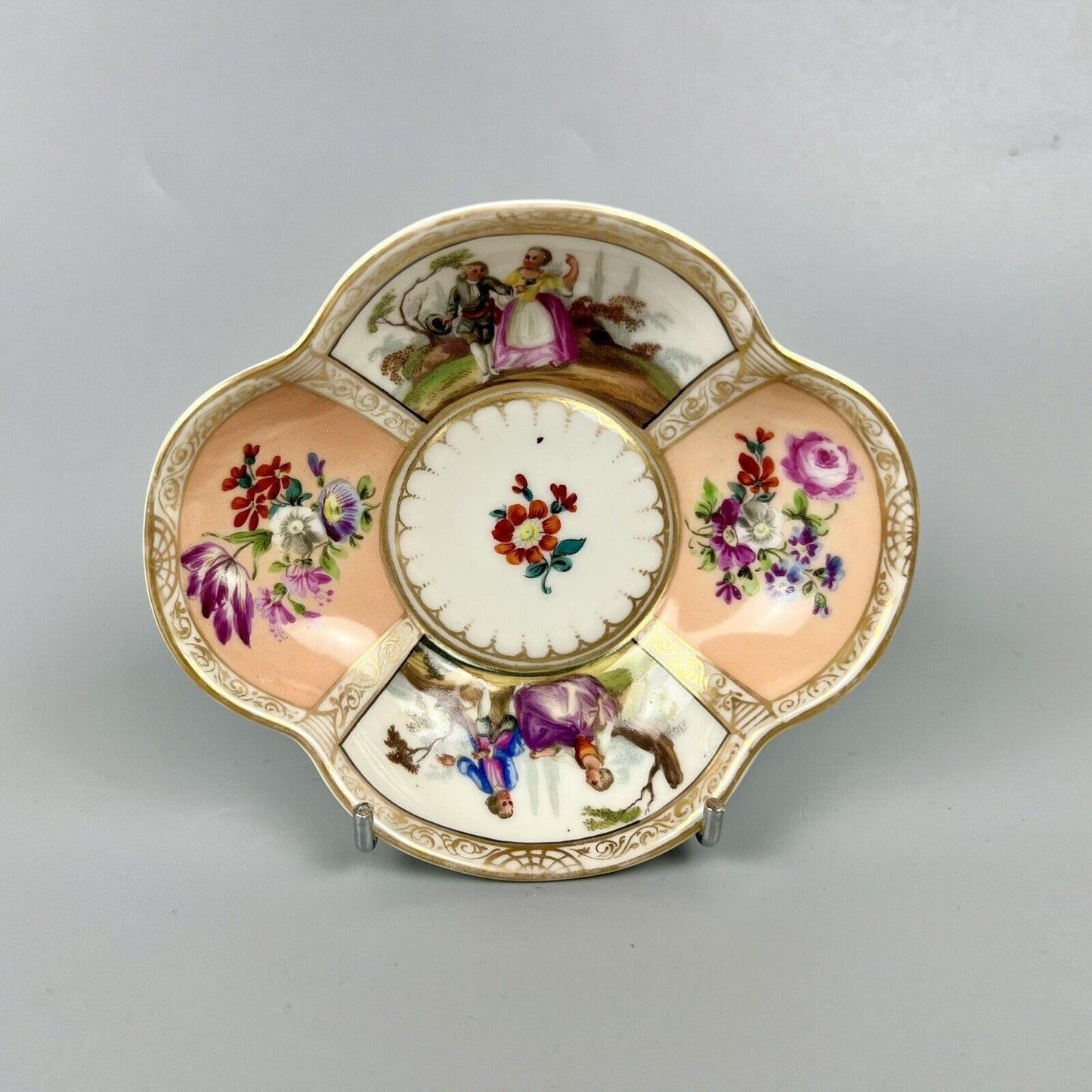 Dresden quatrefoil teacup & saucer painted with romantic scenes. 'AR' mark c1880