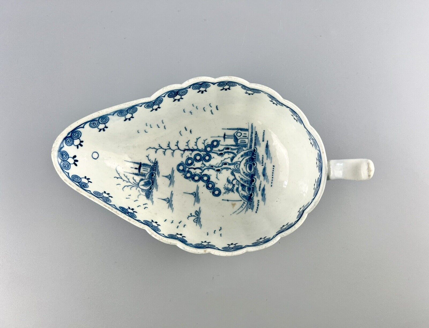 A Worcester First Period "Doughnut Tree" sauceboat. c.1777