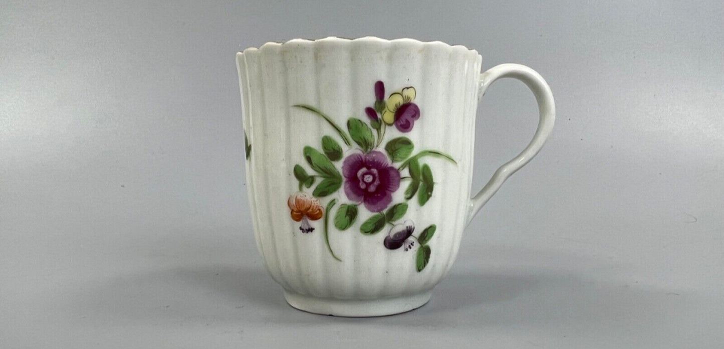 A Worcester reeded French shape coffee cup, painted with flowers and a ladybird