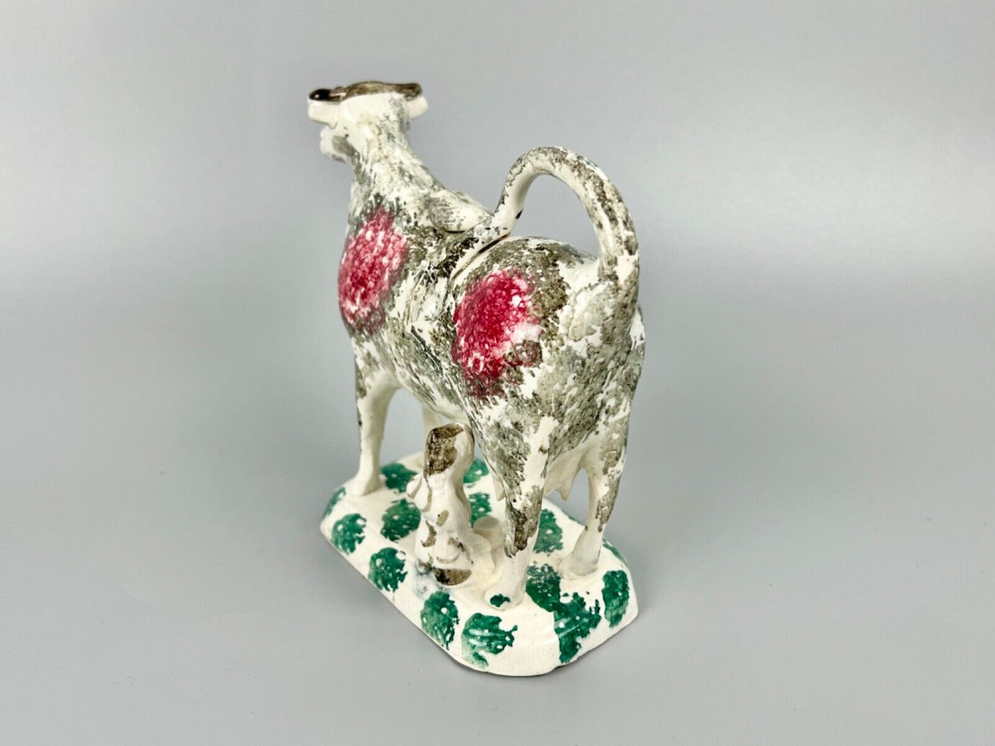 A c.1820 pottery cow and milkmaid creamer in crimson and black. Poss. Yorkshire