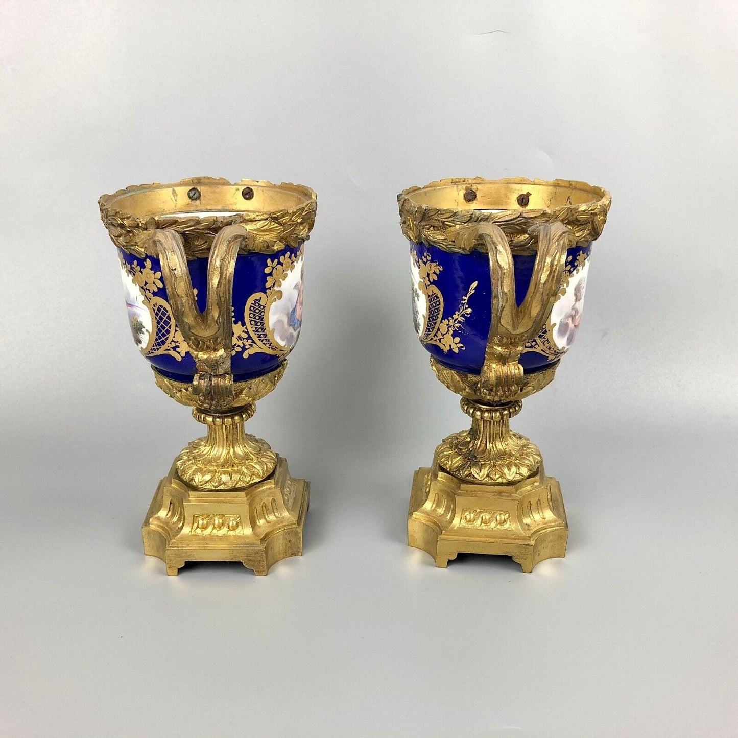 A pair of ormolu Sèvres-style vases painted with exotic birds and putti 1770
