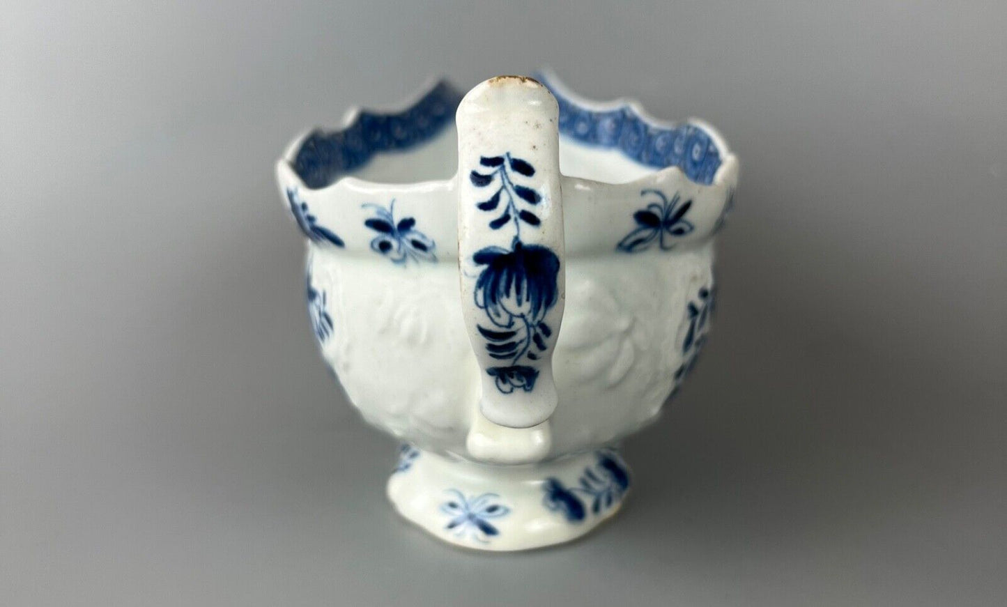 A mid 18thc Bow moulded sauceboat painted in underglaze blue c1765-70