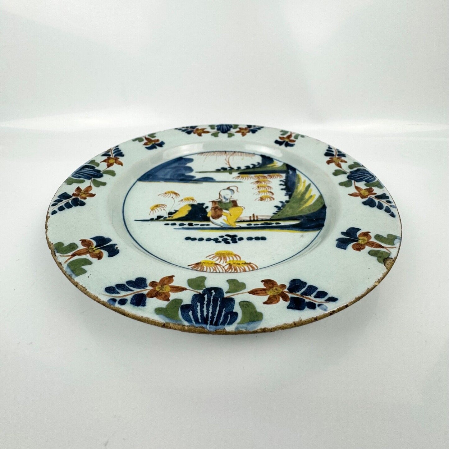 A Lambeth (Abigail Griffiths) delft plate, c.1760, painted in polychrome enamels