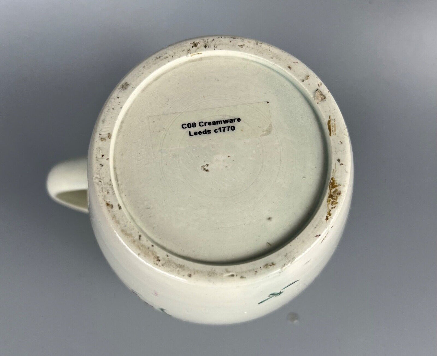 A late 18thc pearlware covered jug. Polychrome floral decoration.