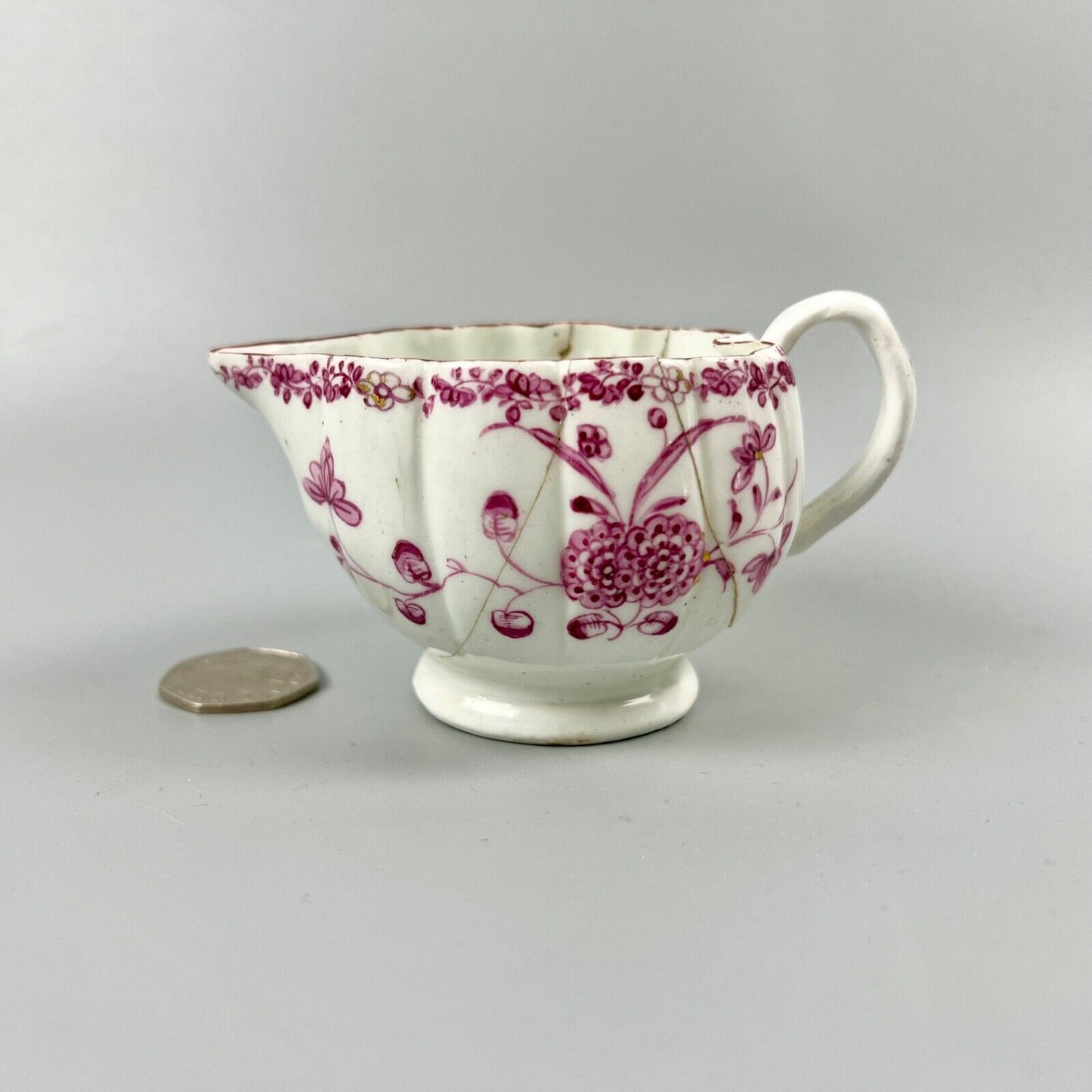 A rare early Derby peach-shaped creamer in 'Banded Hedge' pattern c.1765