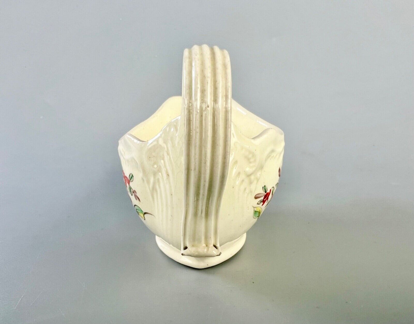 A c1775 creamware sauceboat painted with floral sprays. Probably Staffordshire.