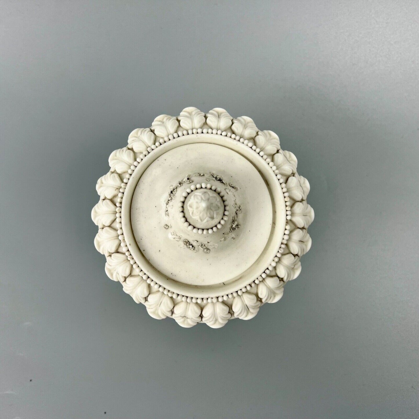 A rare Swansea biscuit lidded urn modelled with flowers and acanthus. c1814-17