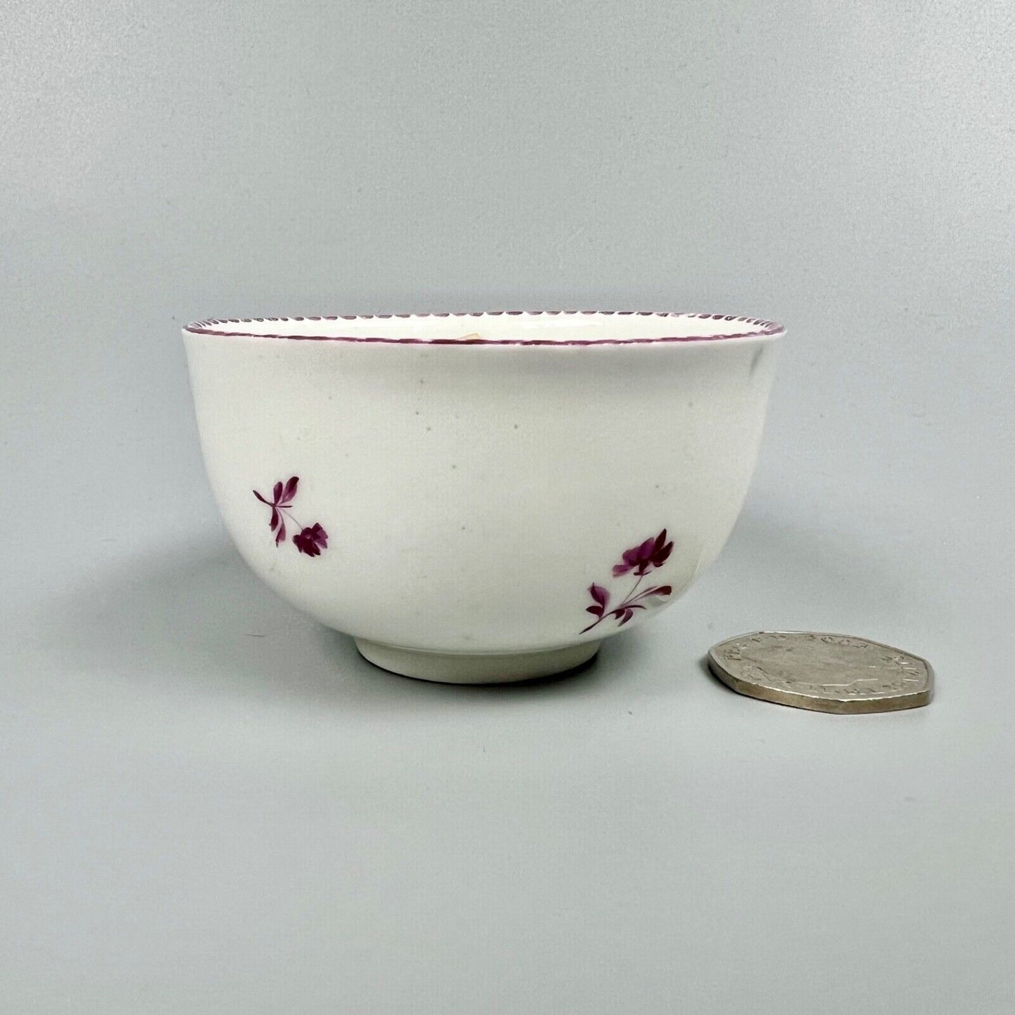 A Vienna porcelain teabowl painted with puce figures c1770-5