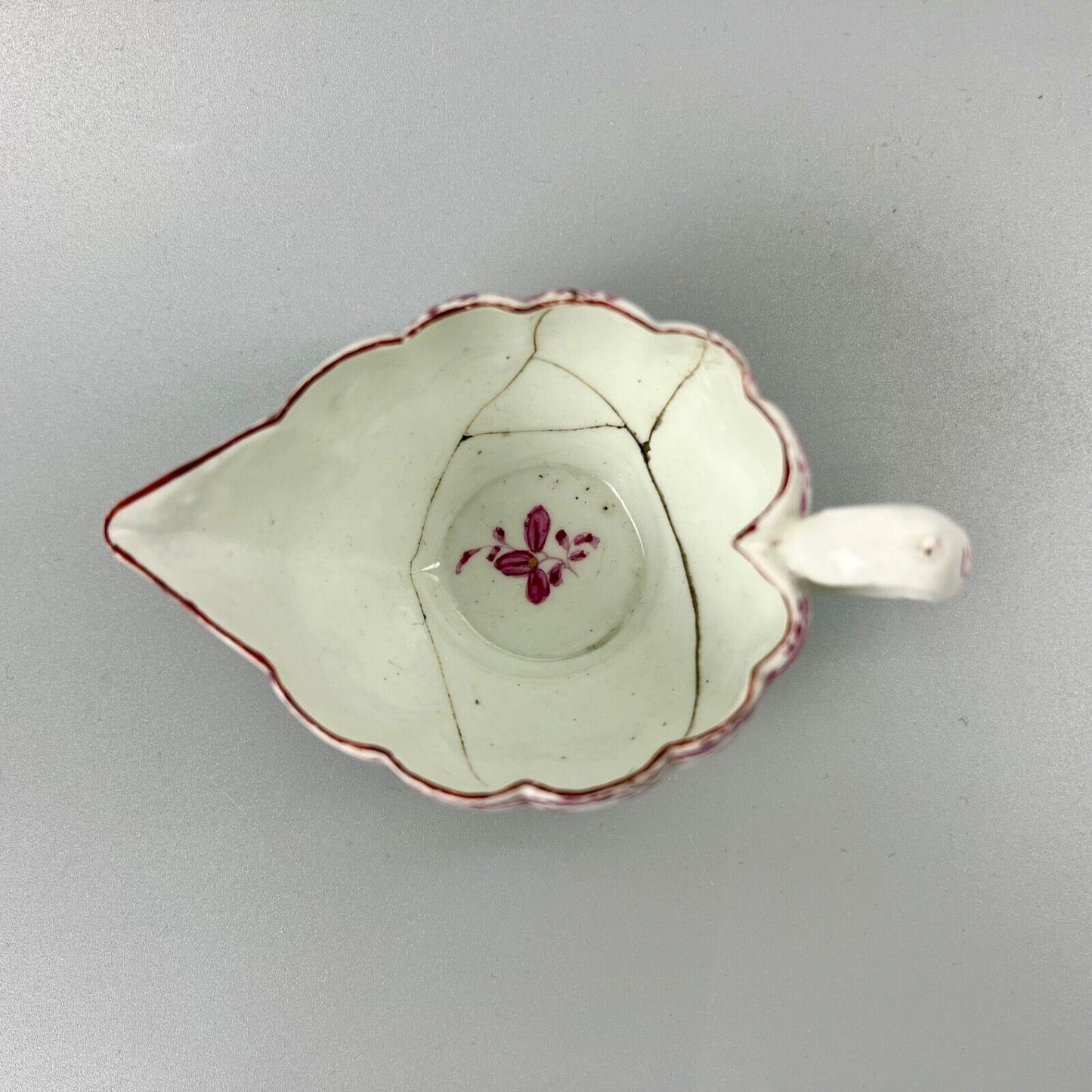 A rare early Derby peach-shaped creamer in 'Banded Hedge' pattern c.1765