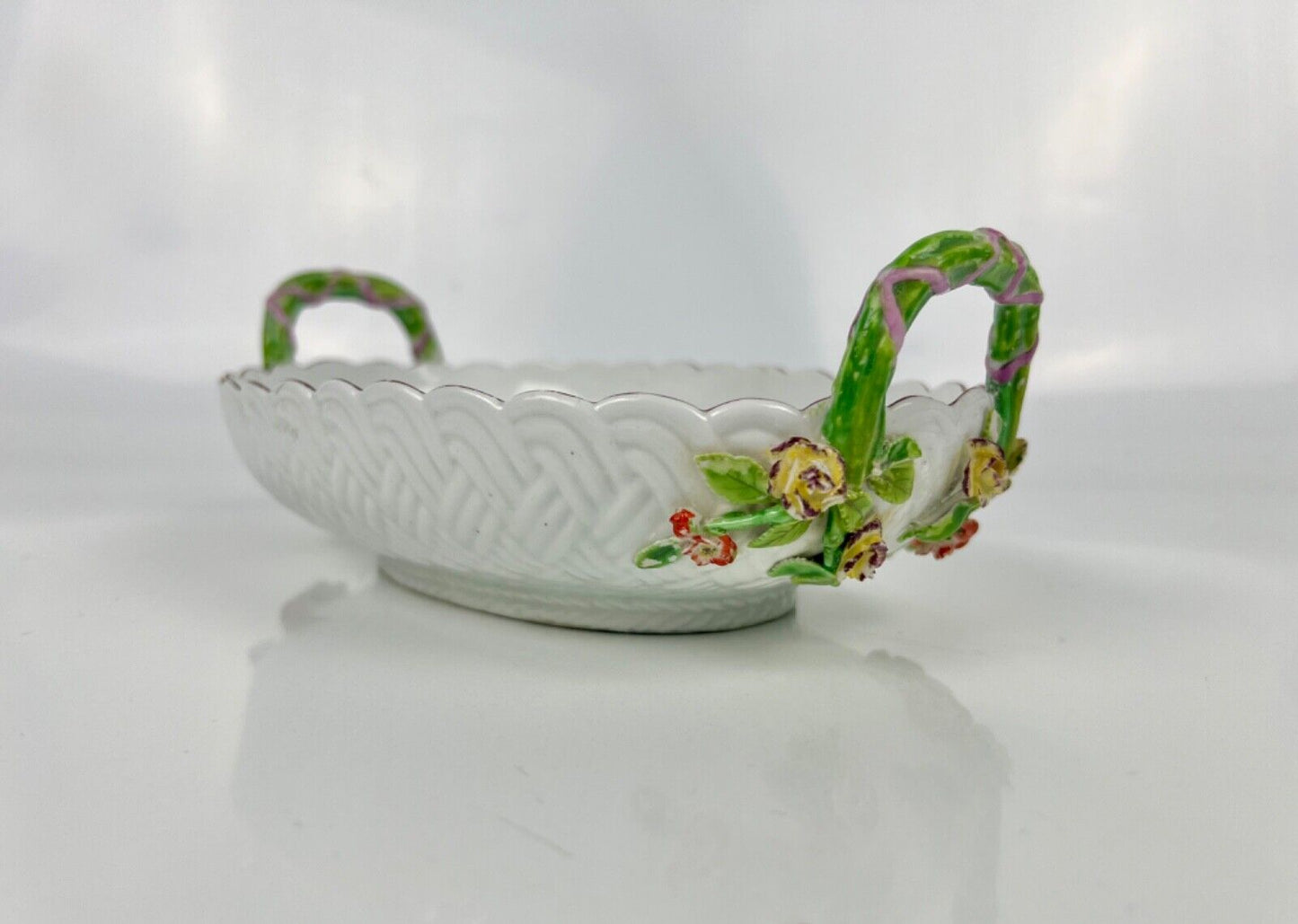 A good Chelsea basketweave moulded basket painted with bouquets. Rustic handles