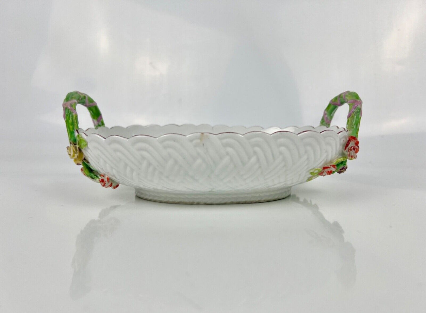 A good Chelsea basketweave moulded basket painted with bouquets. Rustic handles