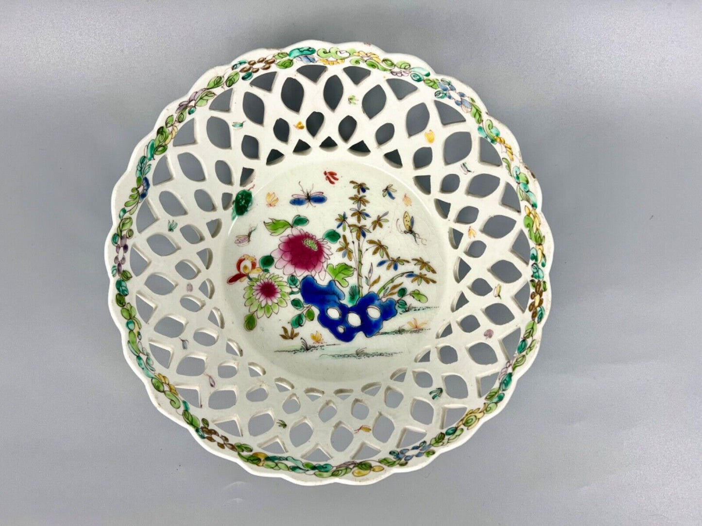 A pair of large Bow porcelain famille rose reticulated baskets c.1752