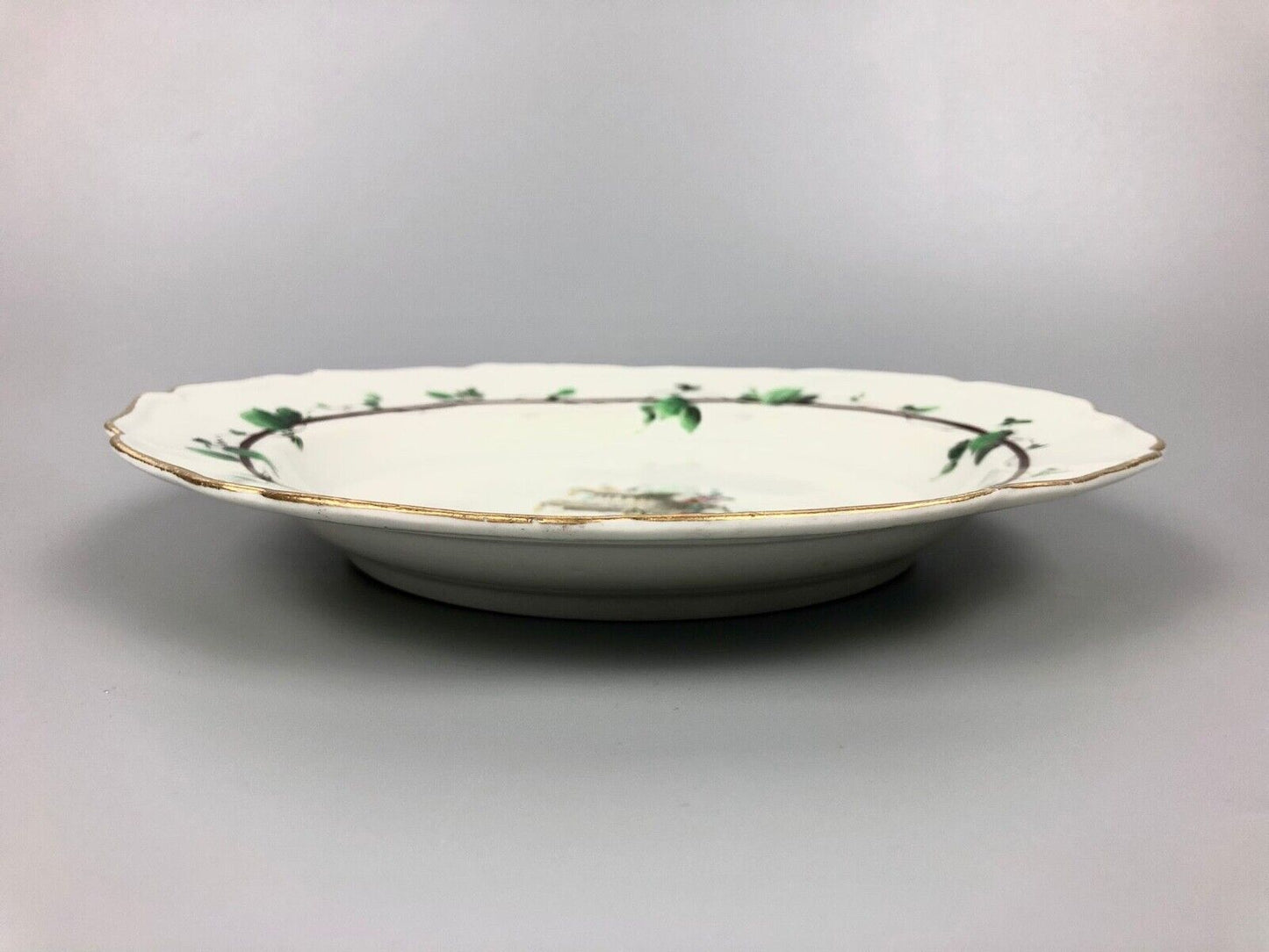 A James Giles decorated 1st Period Worcester plate painted with an urn c.1770