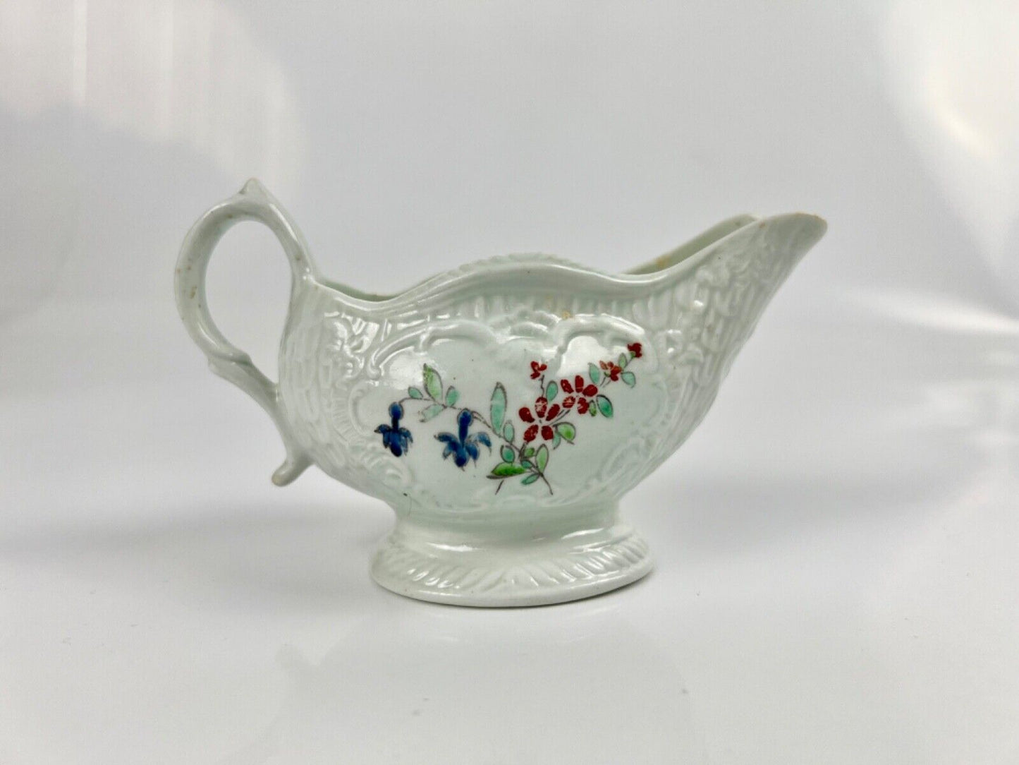 A Philip Christian Liverpool moulded polychrome porcelain sauceboat c.1770