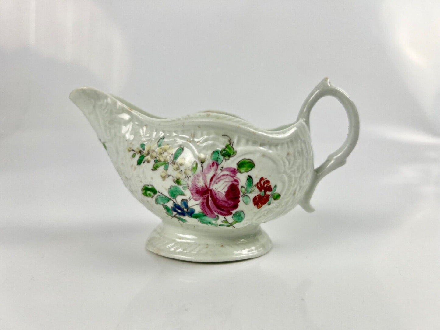 A Philip Christian Liverpool moulded polychrome porcelain sauceboat c.1770
