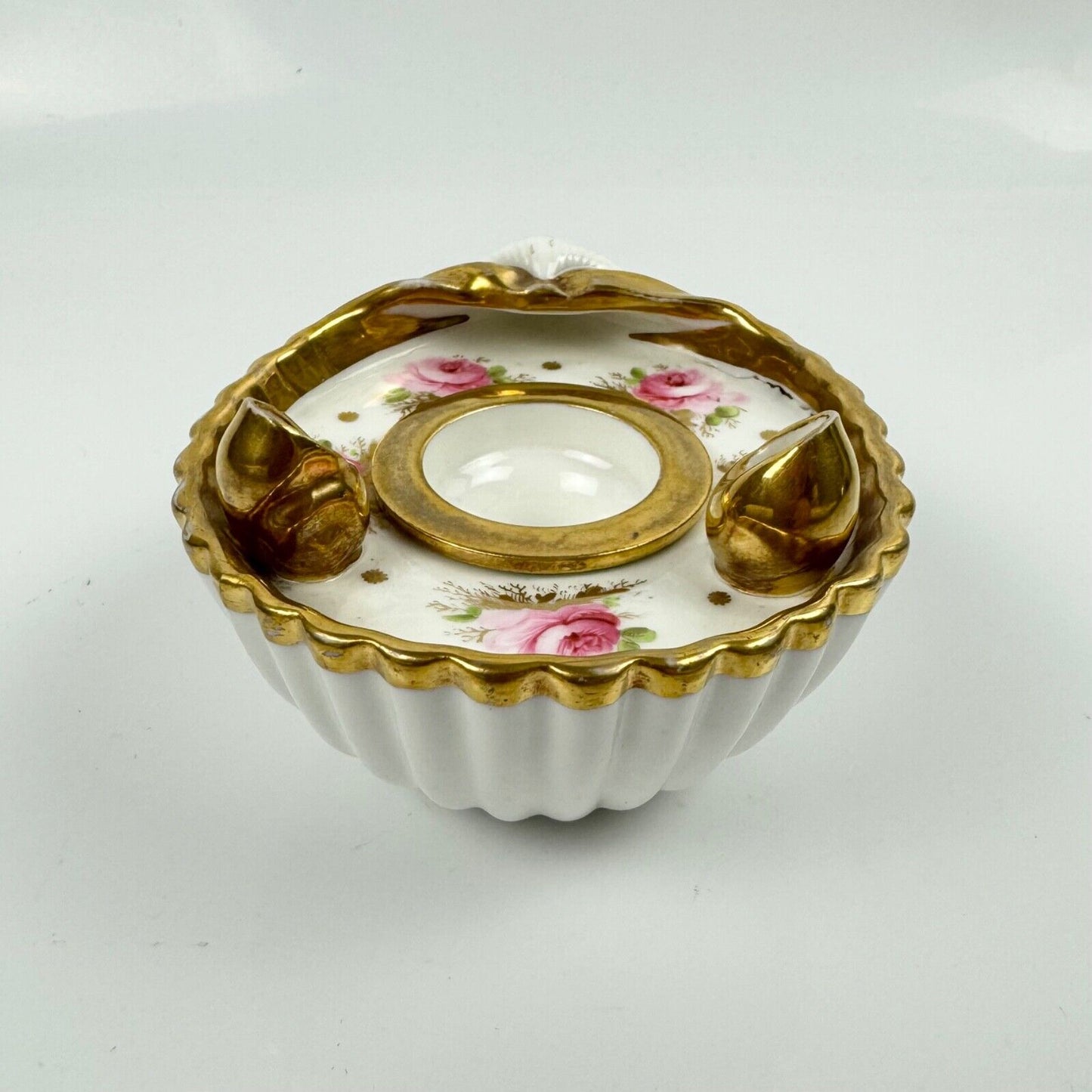 A fine shell-shaped Swansea inkwell and liner painted with roses c1814-26