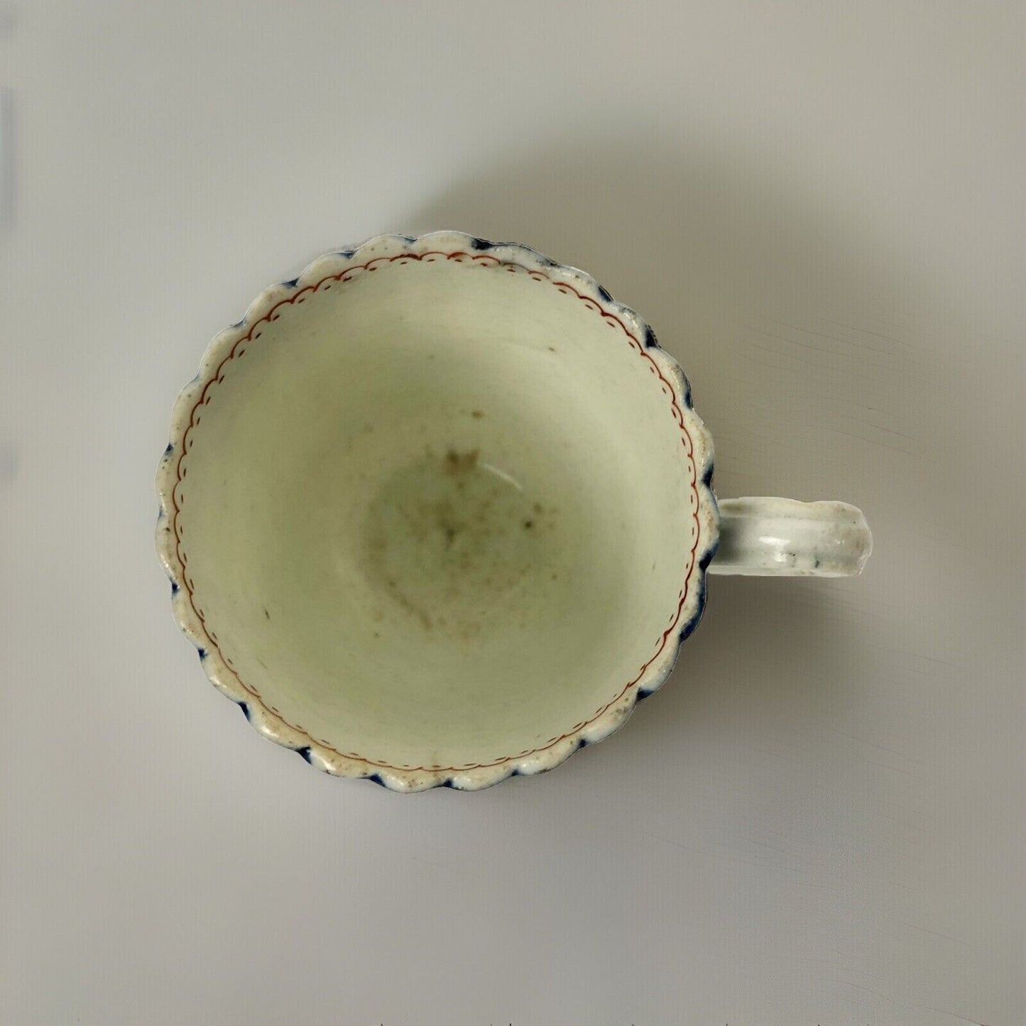 A Seth Pennington fluted coffee cup with blue and gilt border .1780-90