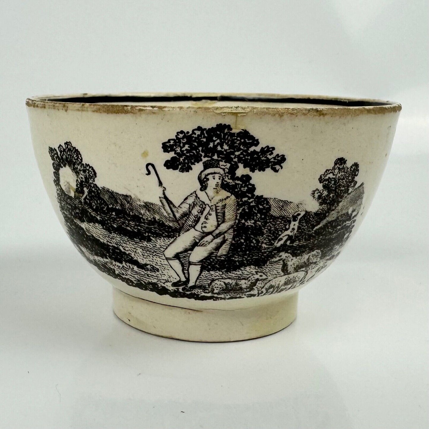 A "tea party" creamware tea bowl and saucer. c.1790. Probably Staffordshire