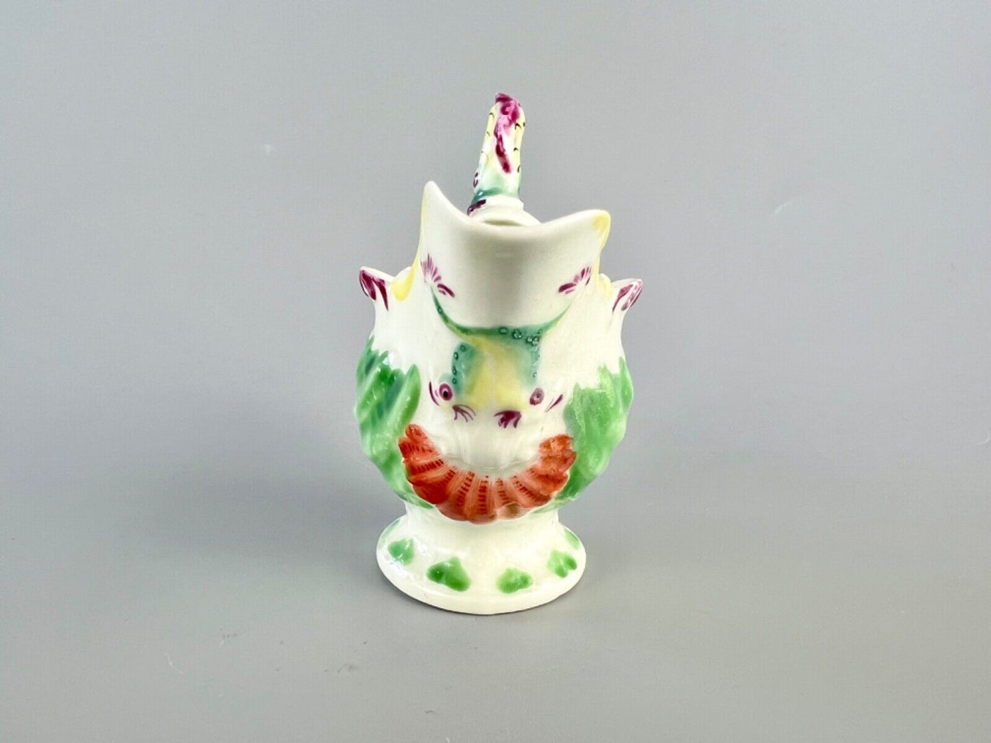 A c.1765 Worcester lamprey-handled dolphin-ewer creamer. Polychrome decoration.