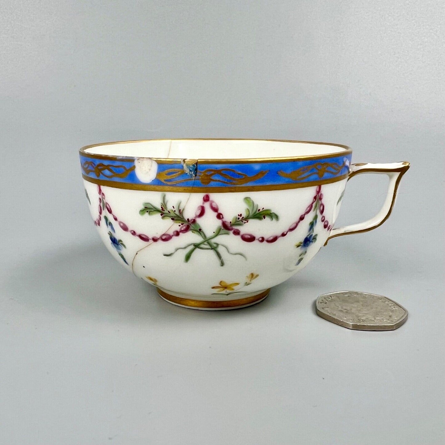A Sèvres teacup painted by Mde Nouallhier. Date mark mm for 1789. Incised mark