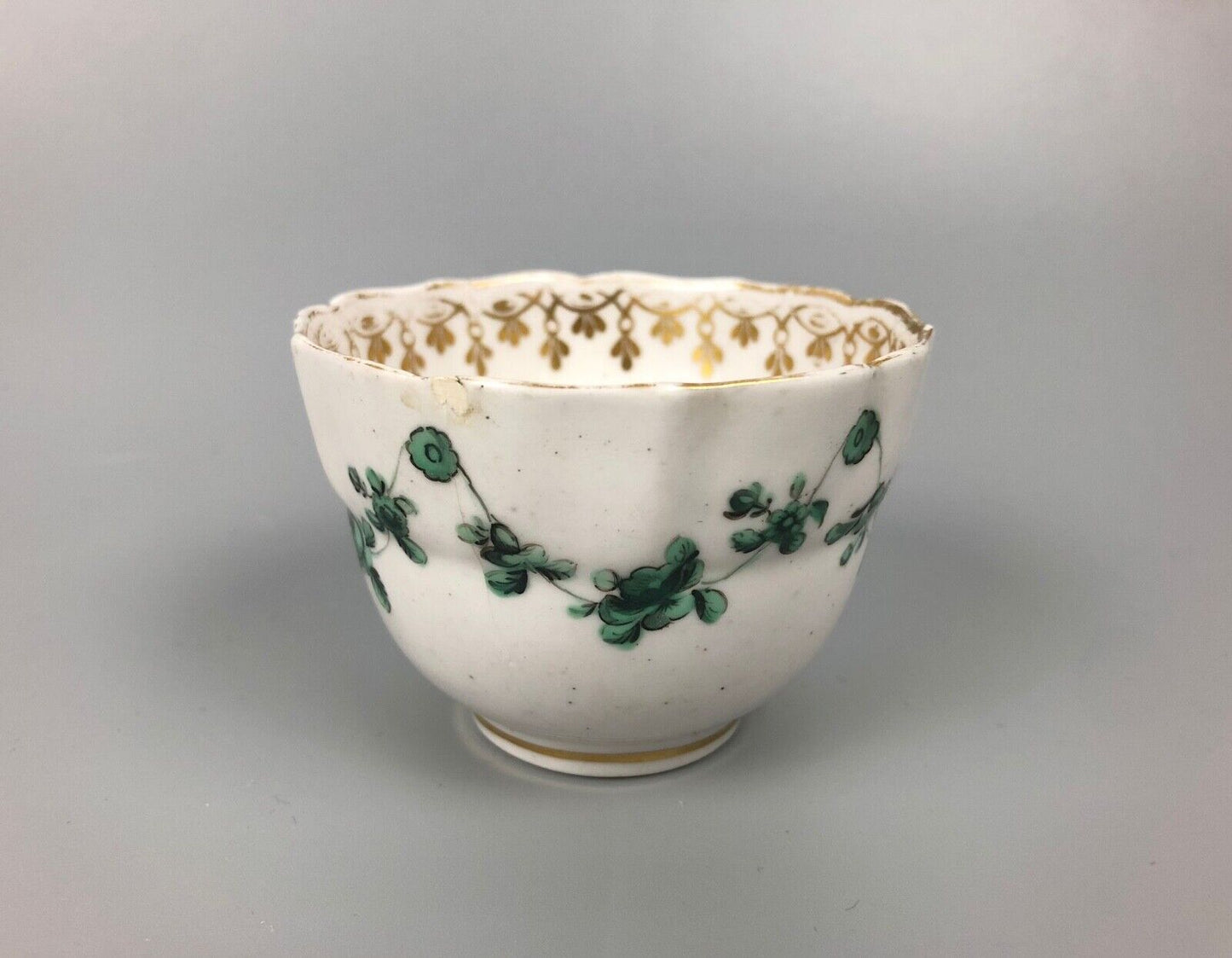 A Derby tea bowl and saucer in the style of Bristol c.1775