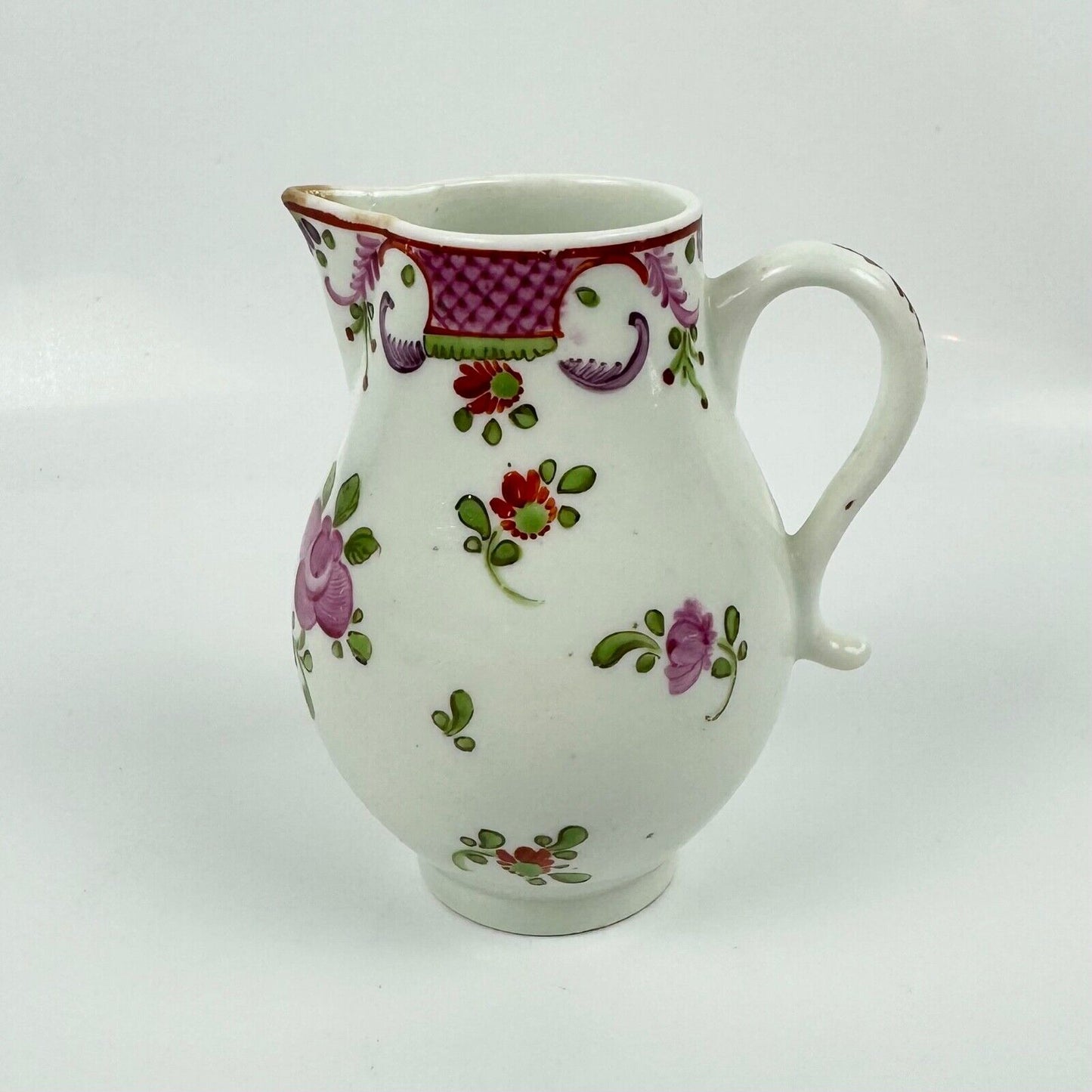 A Lowestoft sparrowbeak creamer c1775 painted with a Curtis style pattern
