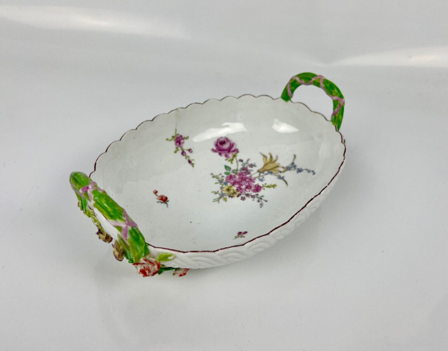 A good Chelsea basketweave moulded basket painted with bouquets. Rustic handles