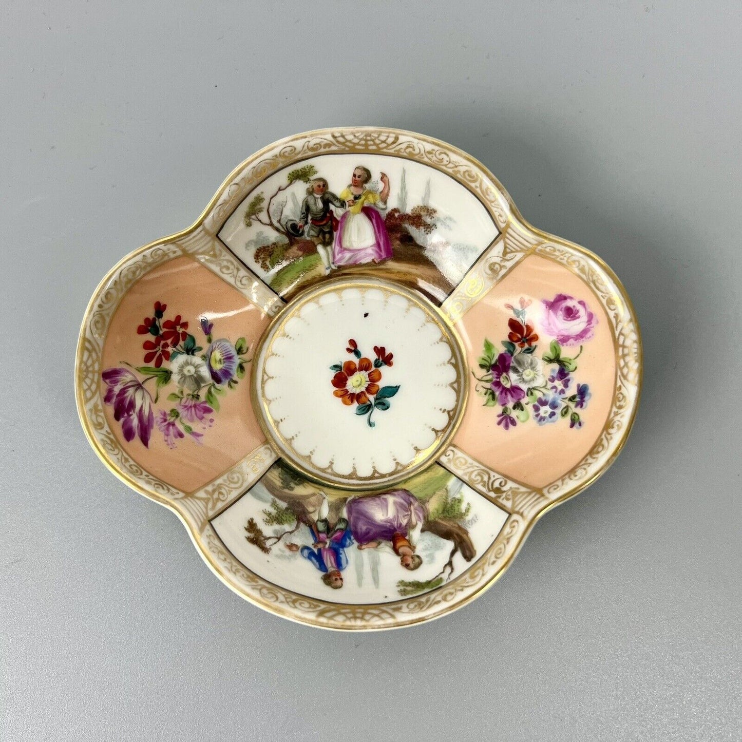 Dresden quatrefoil teacup & saucer painted with romantic scenes. 'AR' mark c1880