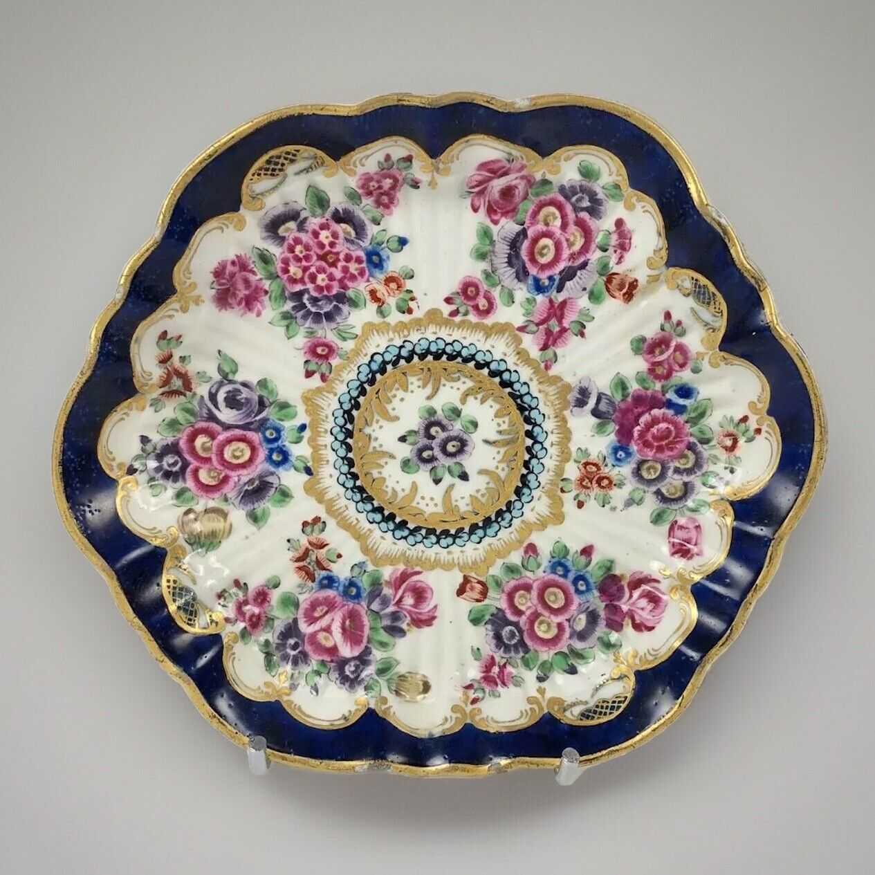 A c1770 later decorated First Period Worcester teapot stand .
