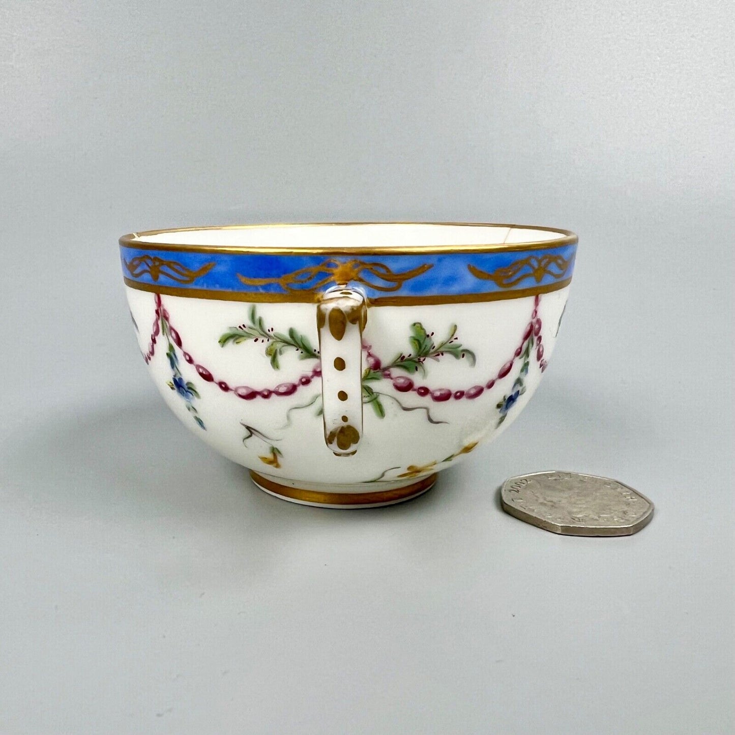 A Sèvres teacup painted by Mde Nouallhier. Date mark mm for 1789. Incised mark