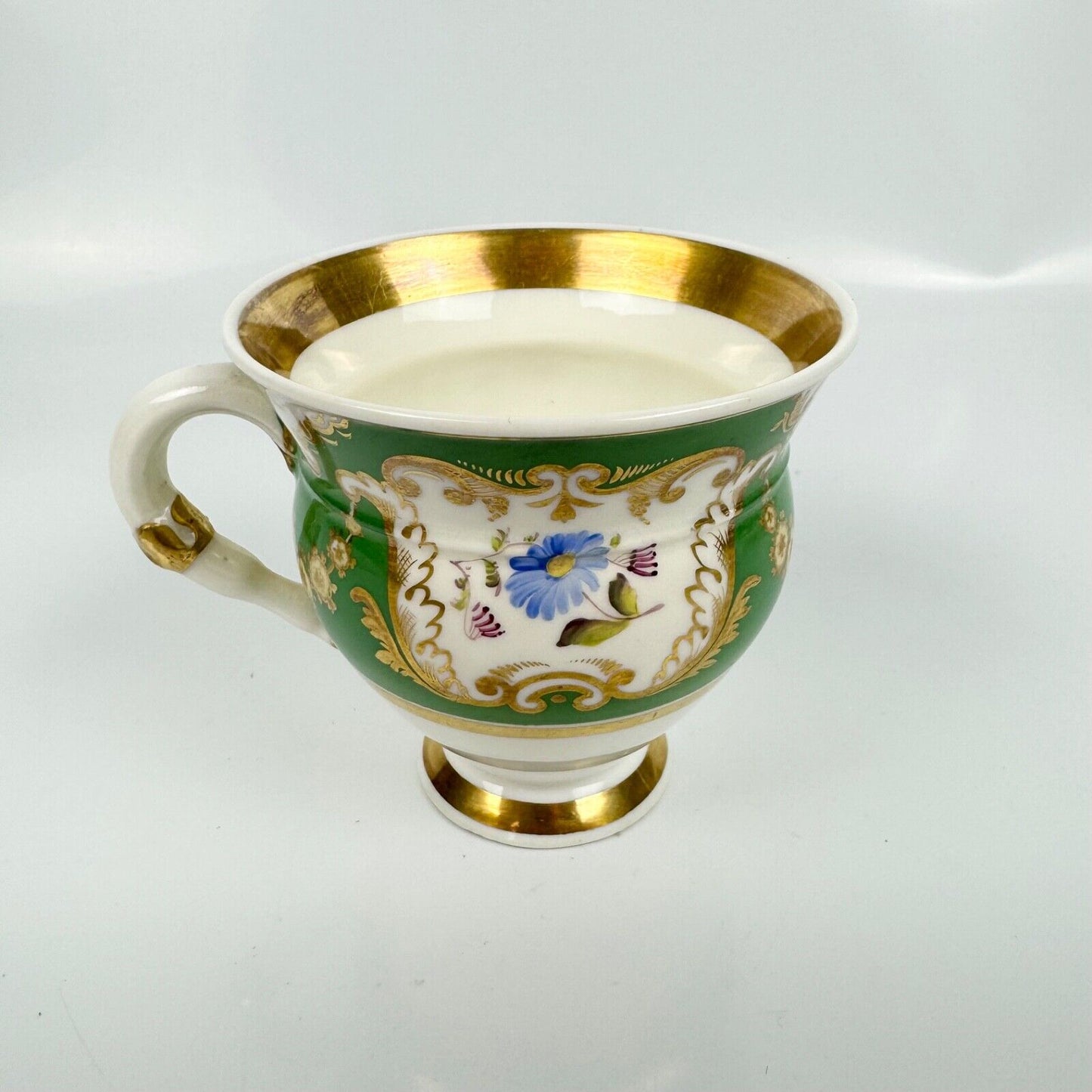 Rockingham horsetail & hoof handled coffee cup& saucer. Red griffin mark. c1826.