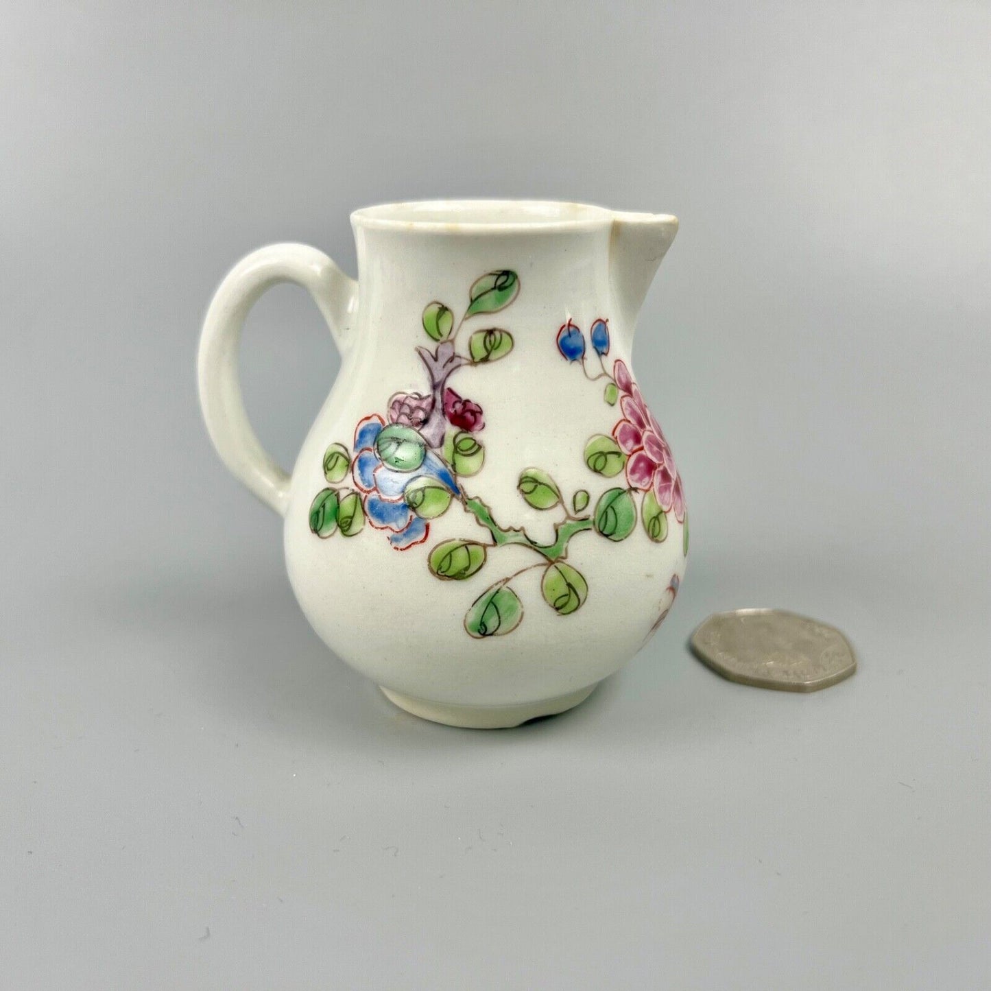 An early Bow creamer painted in famille rose style c1750-3