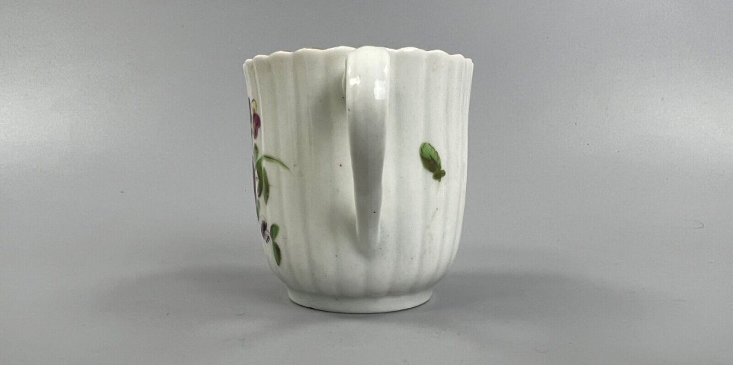 A Worcester reeded French shape coffee cup, painted with flowers and a ladybird