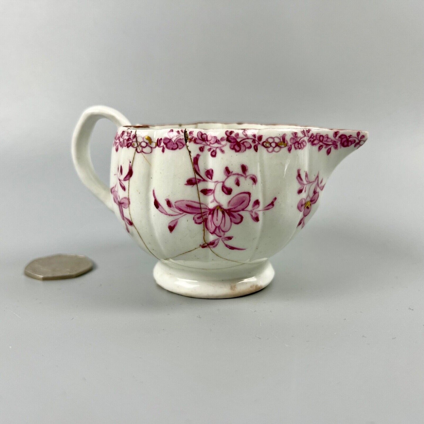A rare early Derby peach-shaped creamer in 'Banded Hedge' pattern c.1765