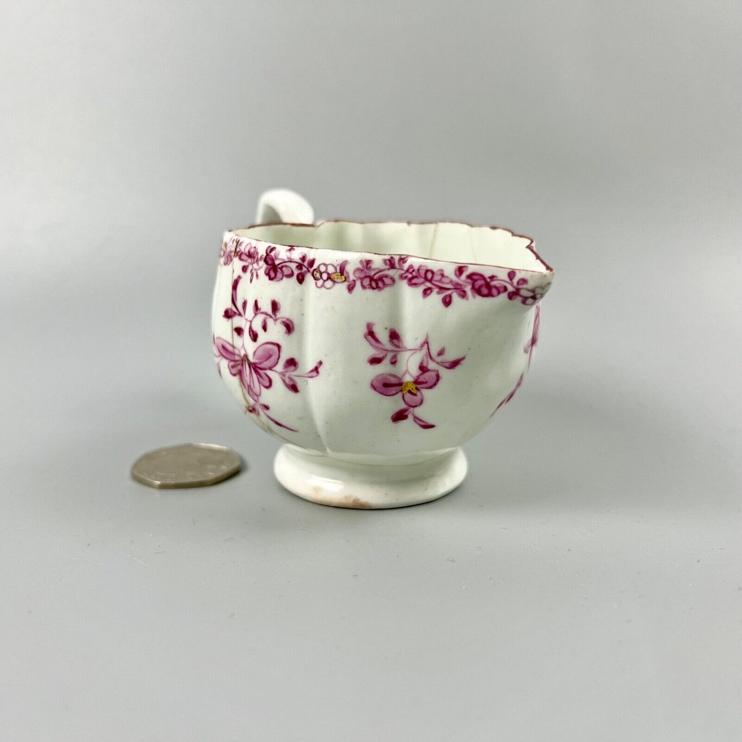 A rare early Derby peach-shaped creamer in 'Banded Hedge' pattern c.1765