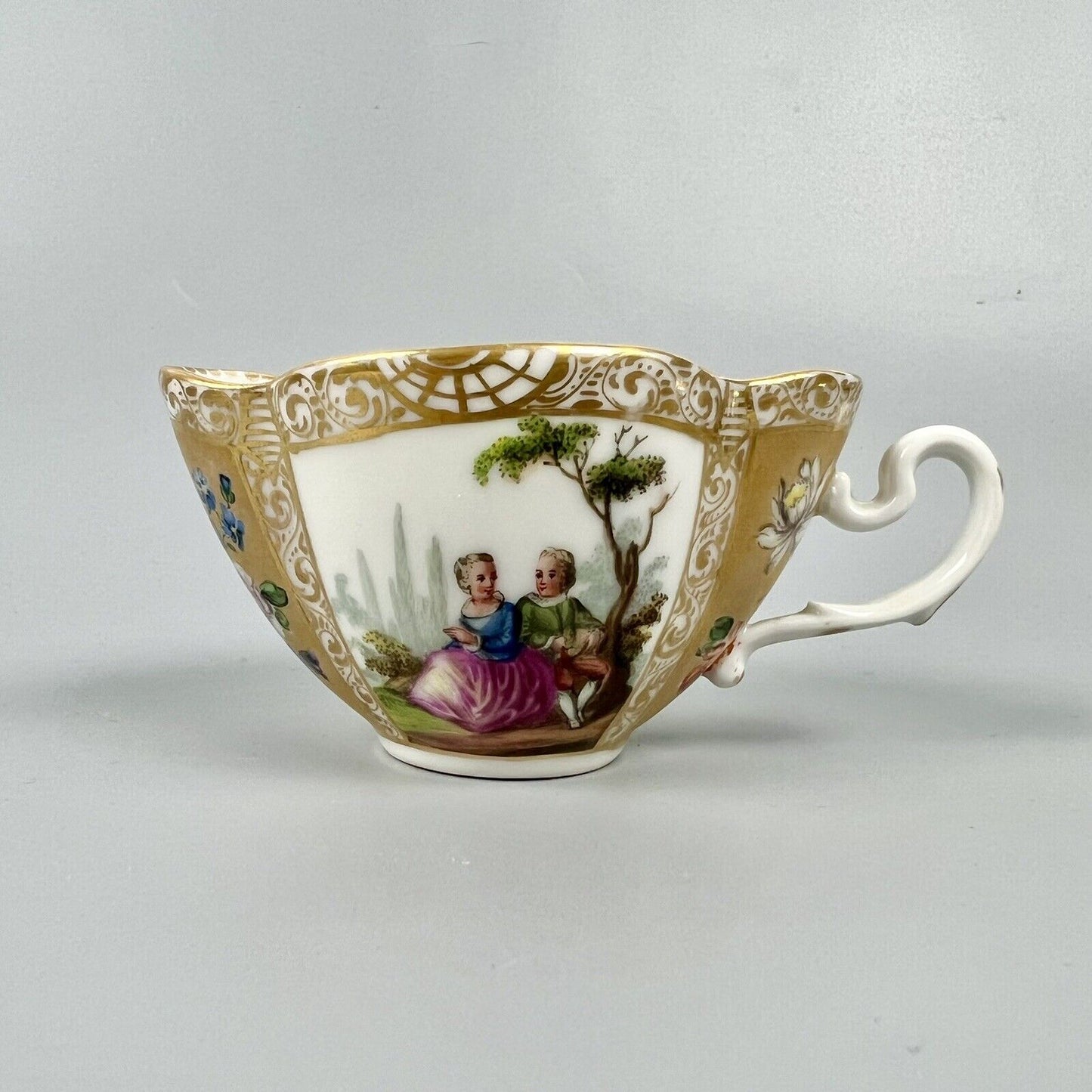 Dresden quatrefoil teacup & saucer painted with romantic scenes. 'AR' mark c1880