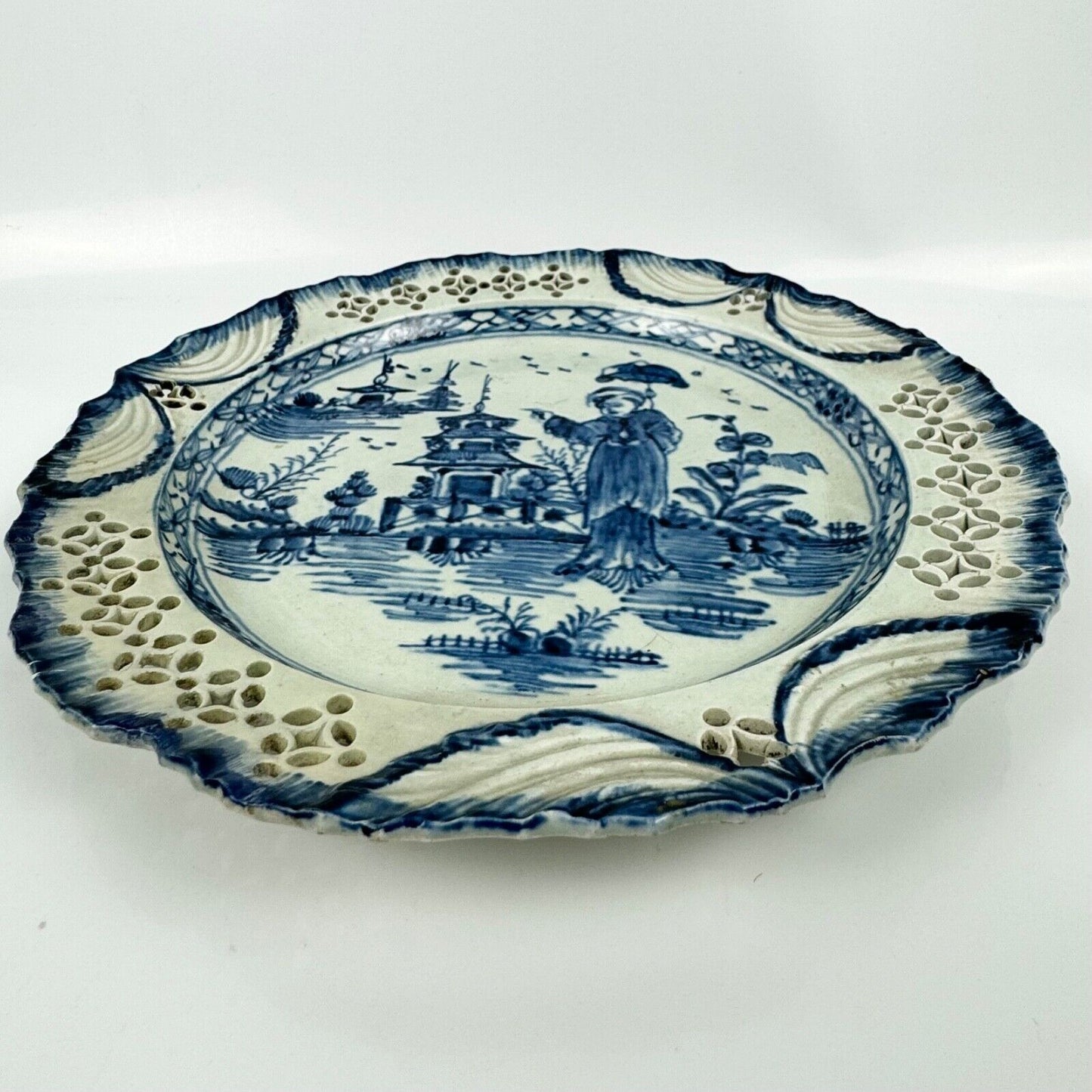 A fine pearlware reticulated plate painted with a 'Long Eliza' figure. c.1790