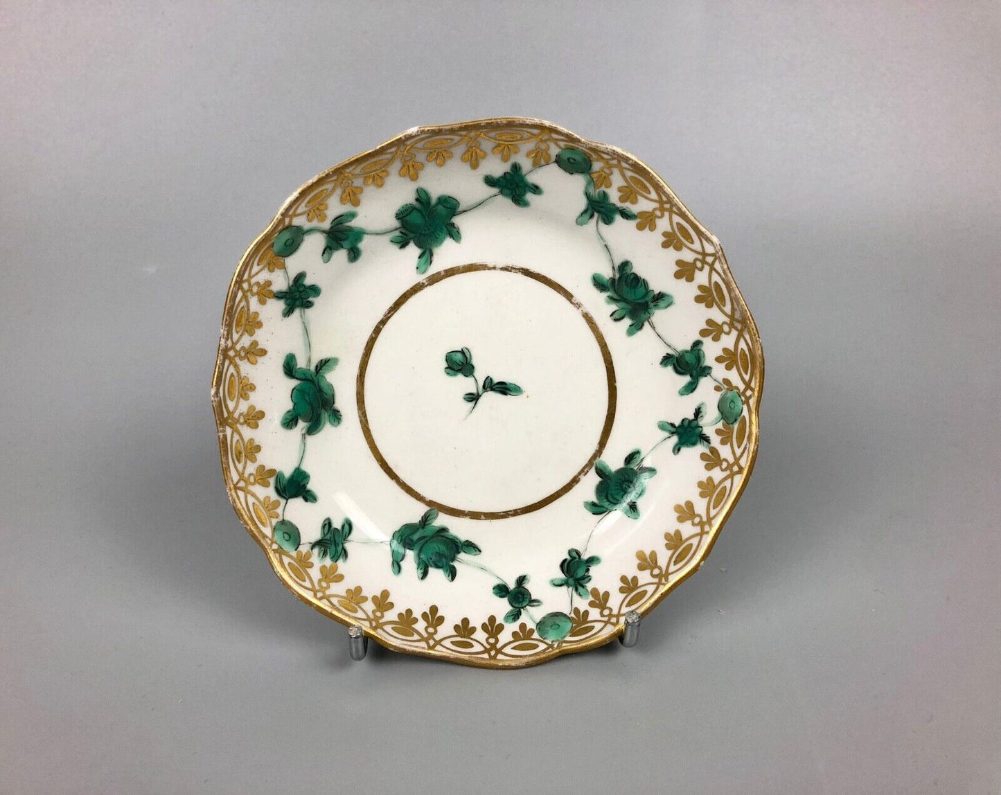 A Derby tea bowl and saucer in the style of Bristol c.1775