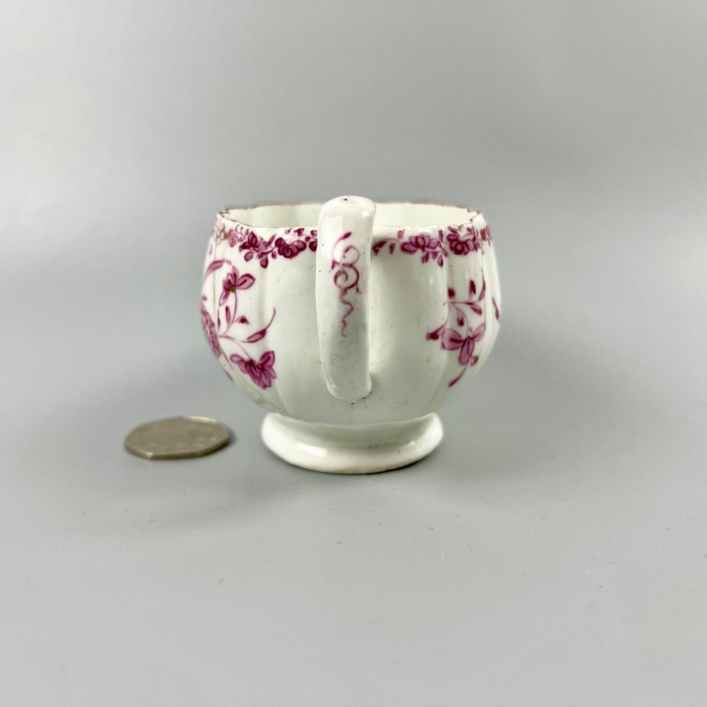 A rare early Derby peach-shaped creamer in 'Banded Hedge' pattern c.1765
