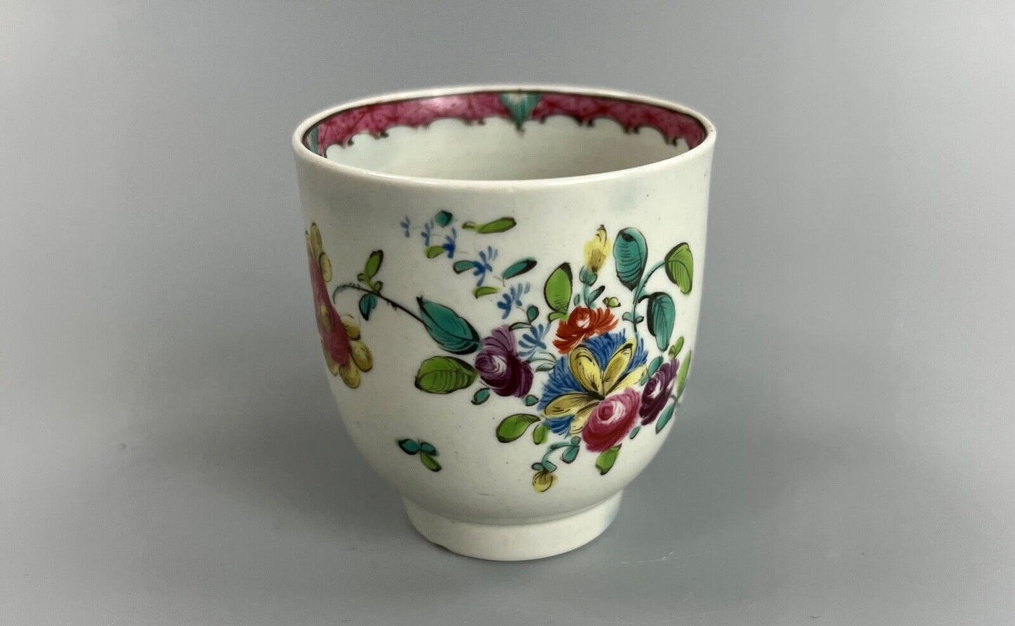 A Seth Pennington Liverpool coffee cup w/painted border & floral decoration