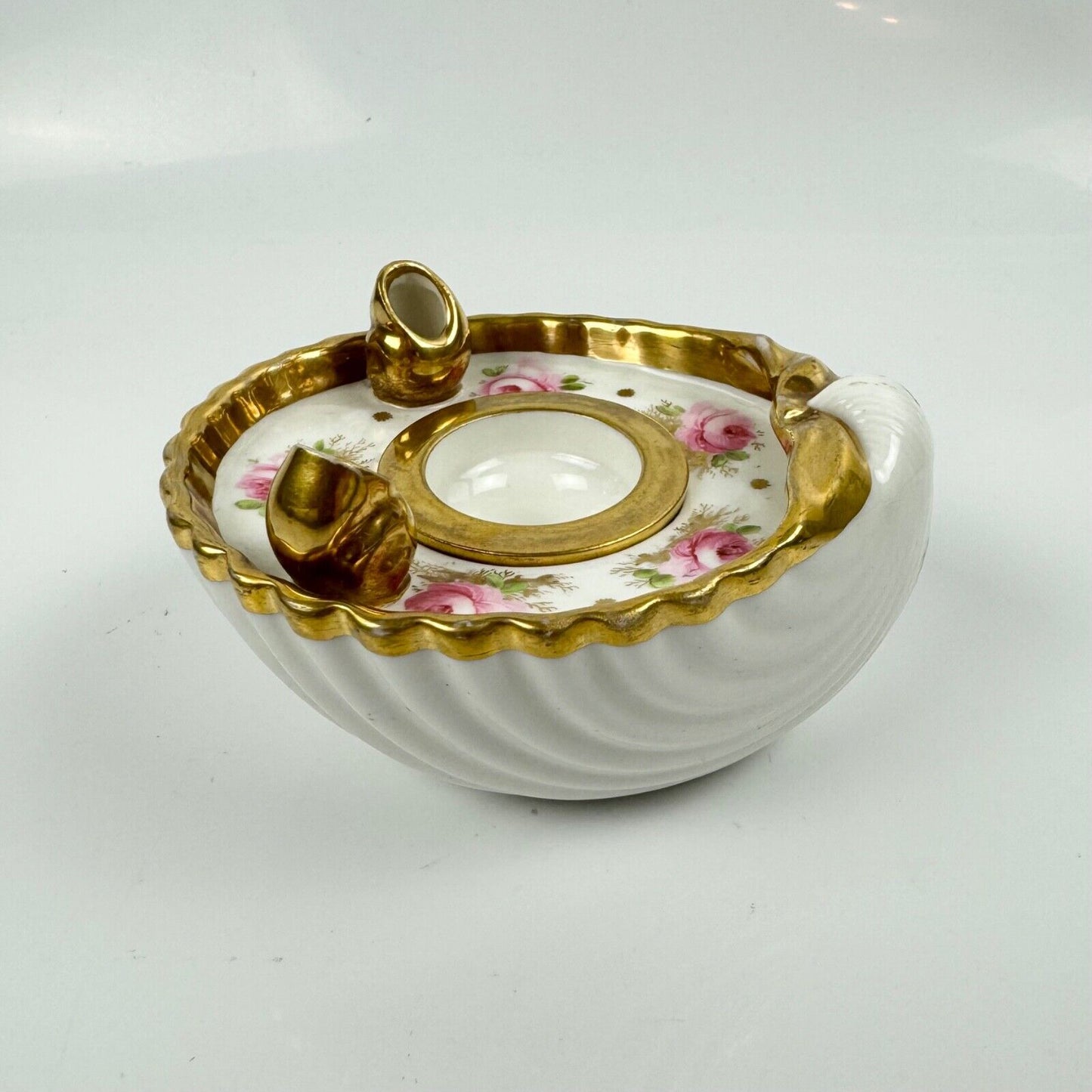 A fine shell-shaped Swansea inkwell and liner painted with roses c1814-26