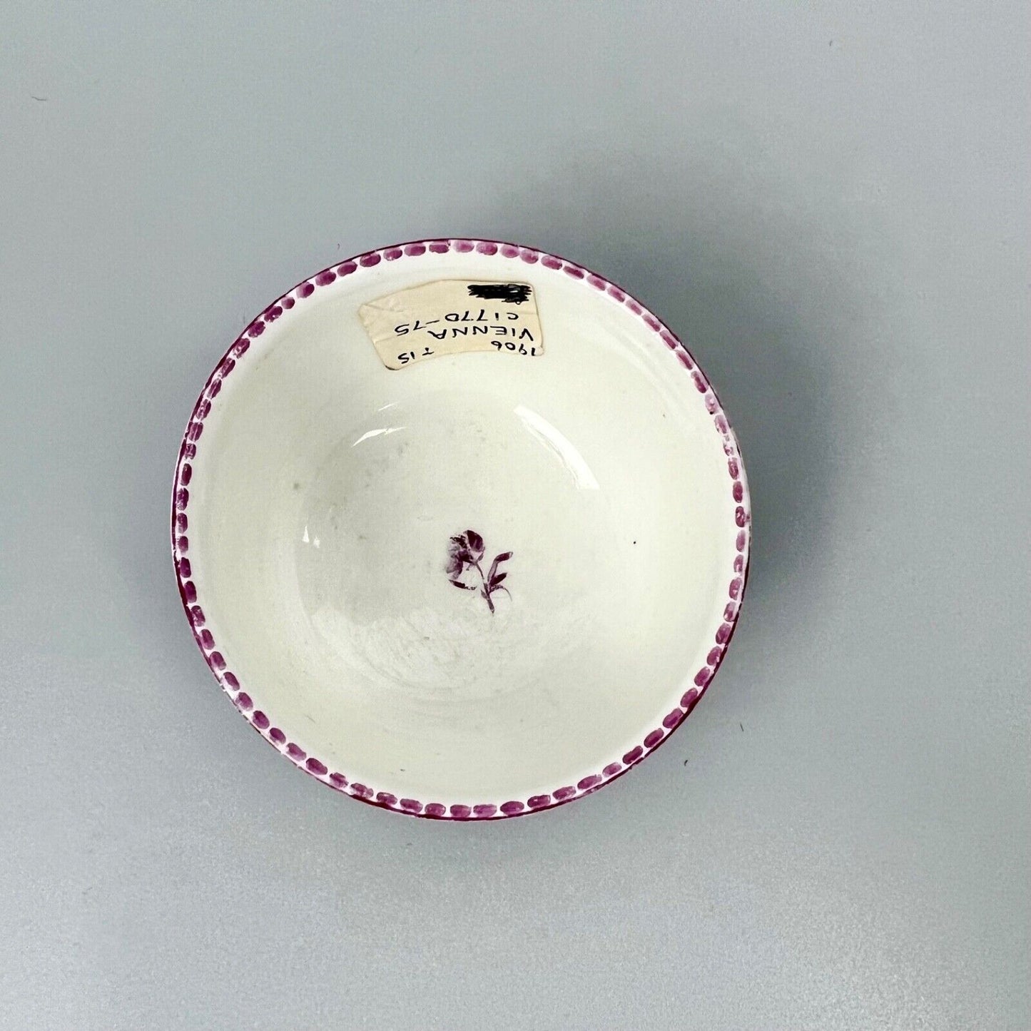 A Vienna porcelain teabowl painted with puce figures c1770-5
