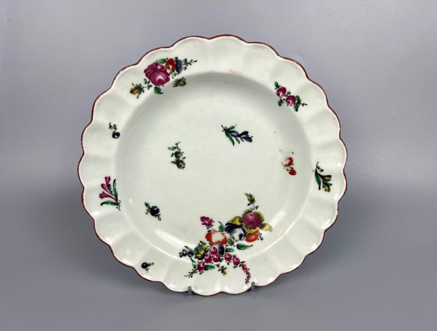 A 1st Period Worcester scalloped dessert plate painted with flowers c.1775