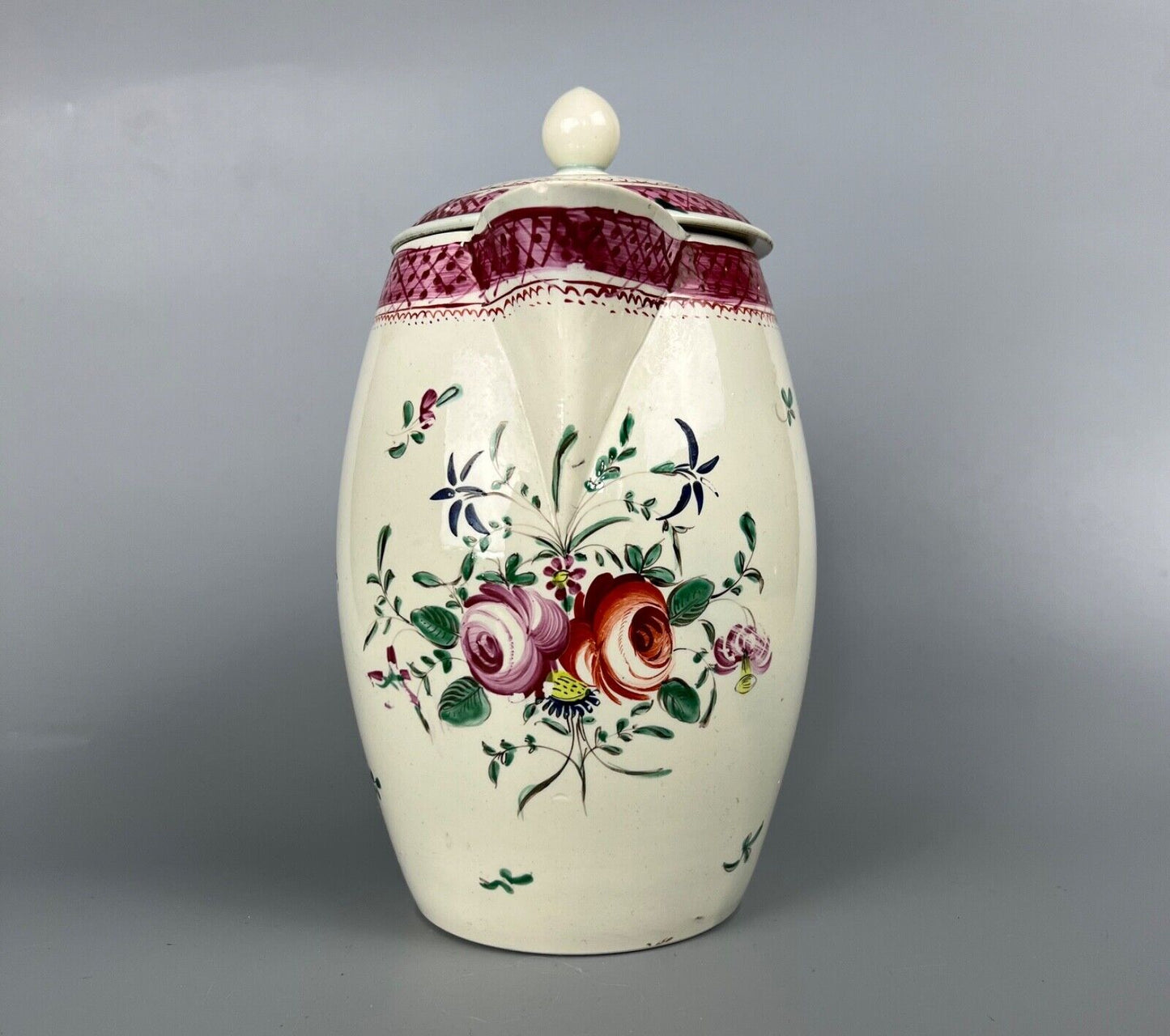 A late 18thc pearlware covered jug. Polychrome floral decoration.