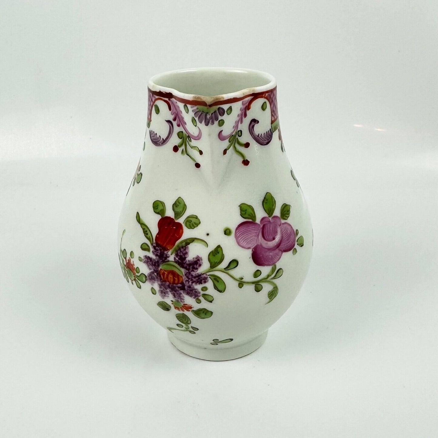 A Lowestoft sparrowbeak creamer c1775 painted with a Curtis style pattern